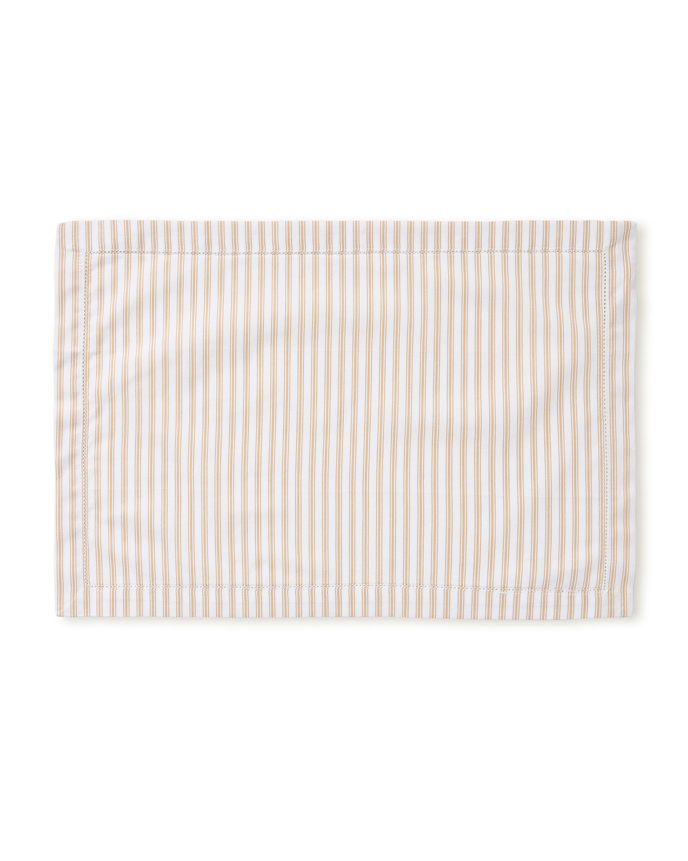 A Signature Twill Placemat in Camel Ticking, featuring light brown and white vertical stripes, is neatly laid flat on a white background.