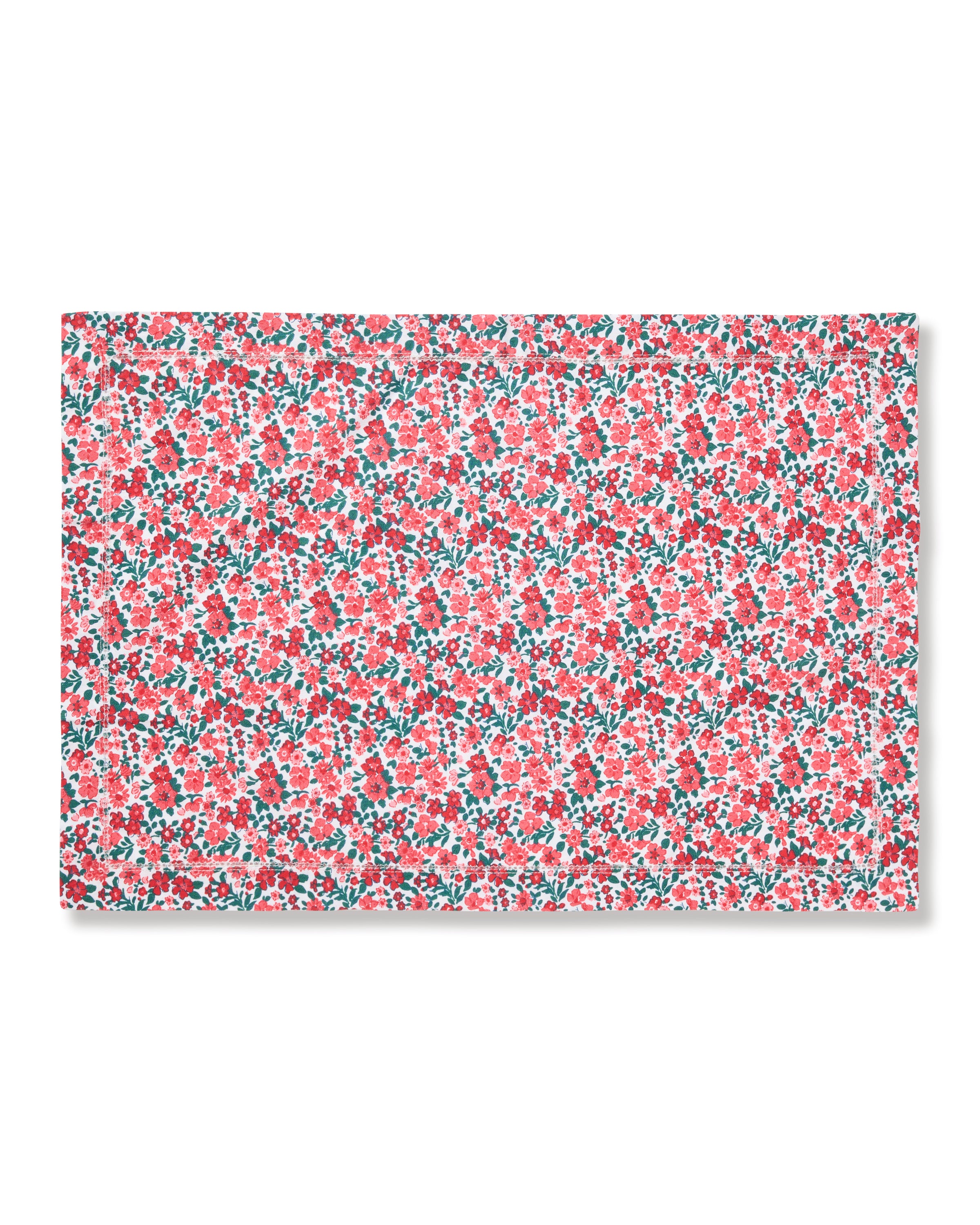 The Signature Twill Placemats in Fleurs des Bois feature a dense floral pattern with red, pink, and white flowers and green leaves on a white background.
