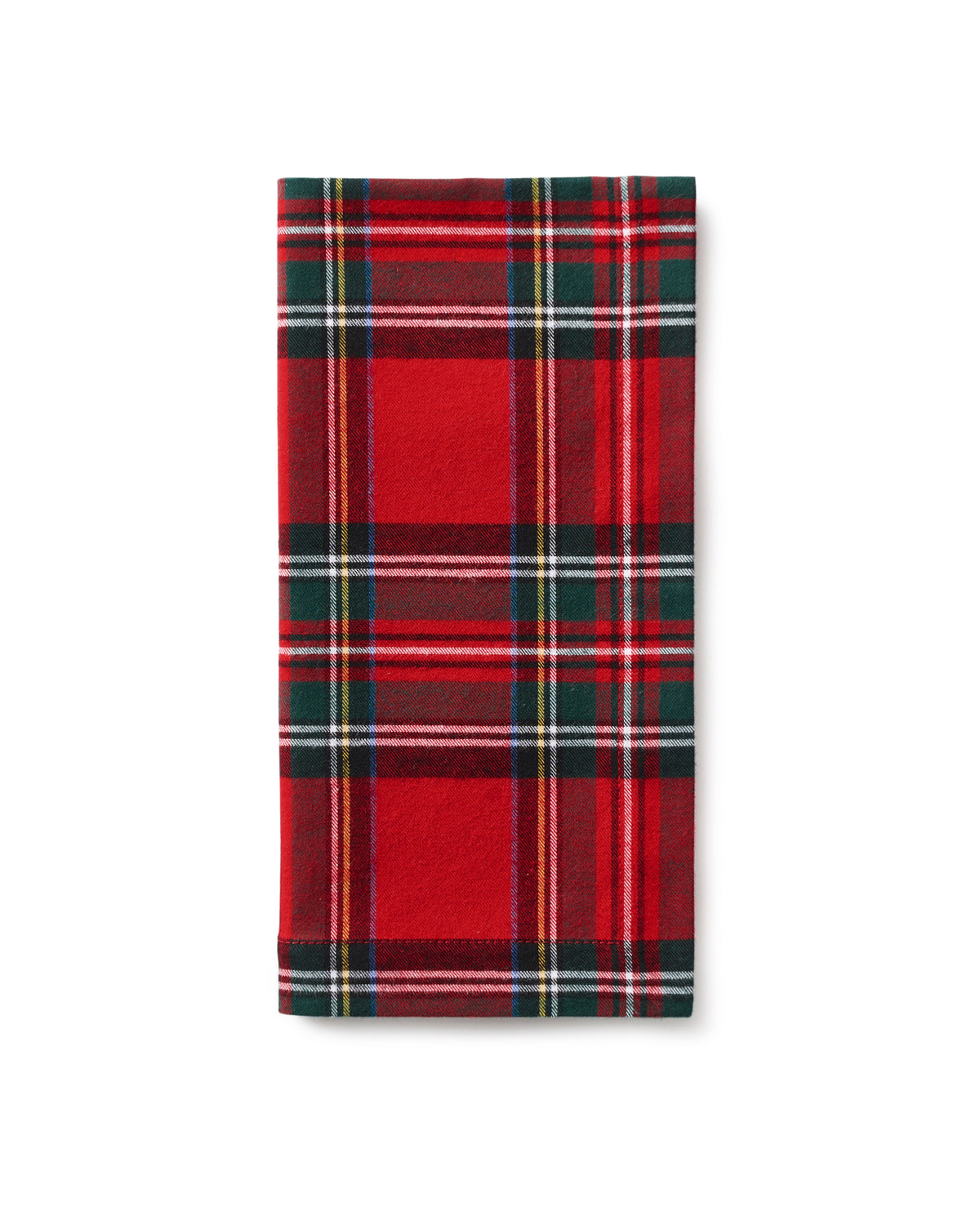 A dining table set featuring Signature Twill Napkins in Imperial Tartan by Petite Plume crafted from cotton textiles. Silver cutlery accompanies white plates, while crystal glassware and a small candle holder enhance the festive tablescape, creating an elegant setting.