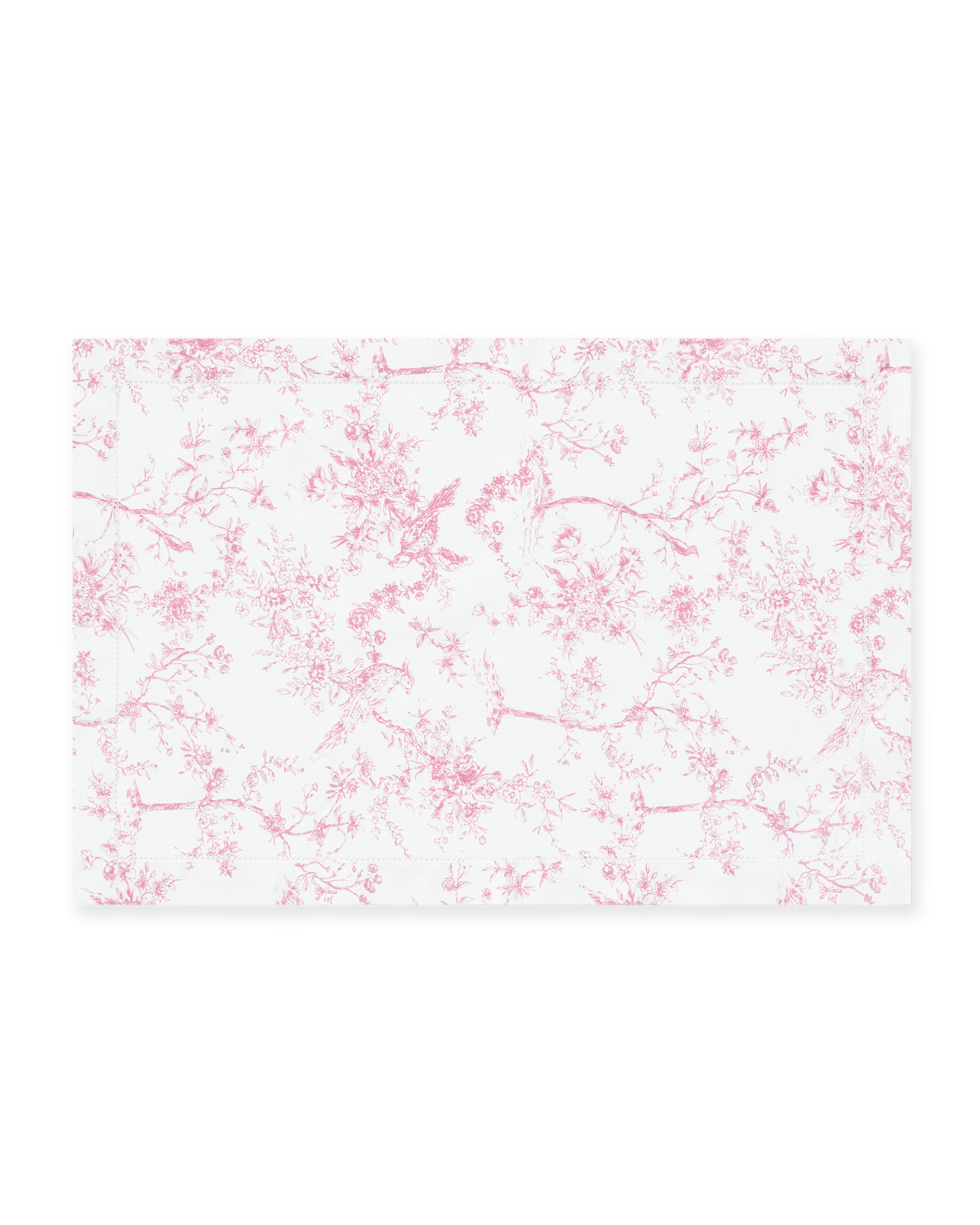Signature Twill Placemats in Pink Timeless Toile feature a rectangular white cloth with a delicate pink floral and bird toile pattern.