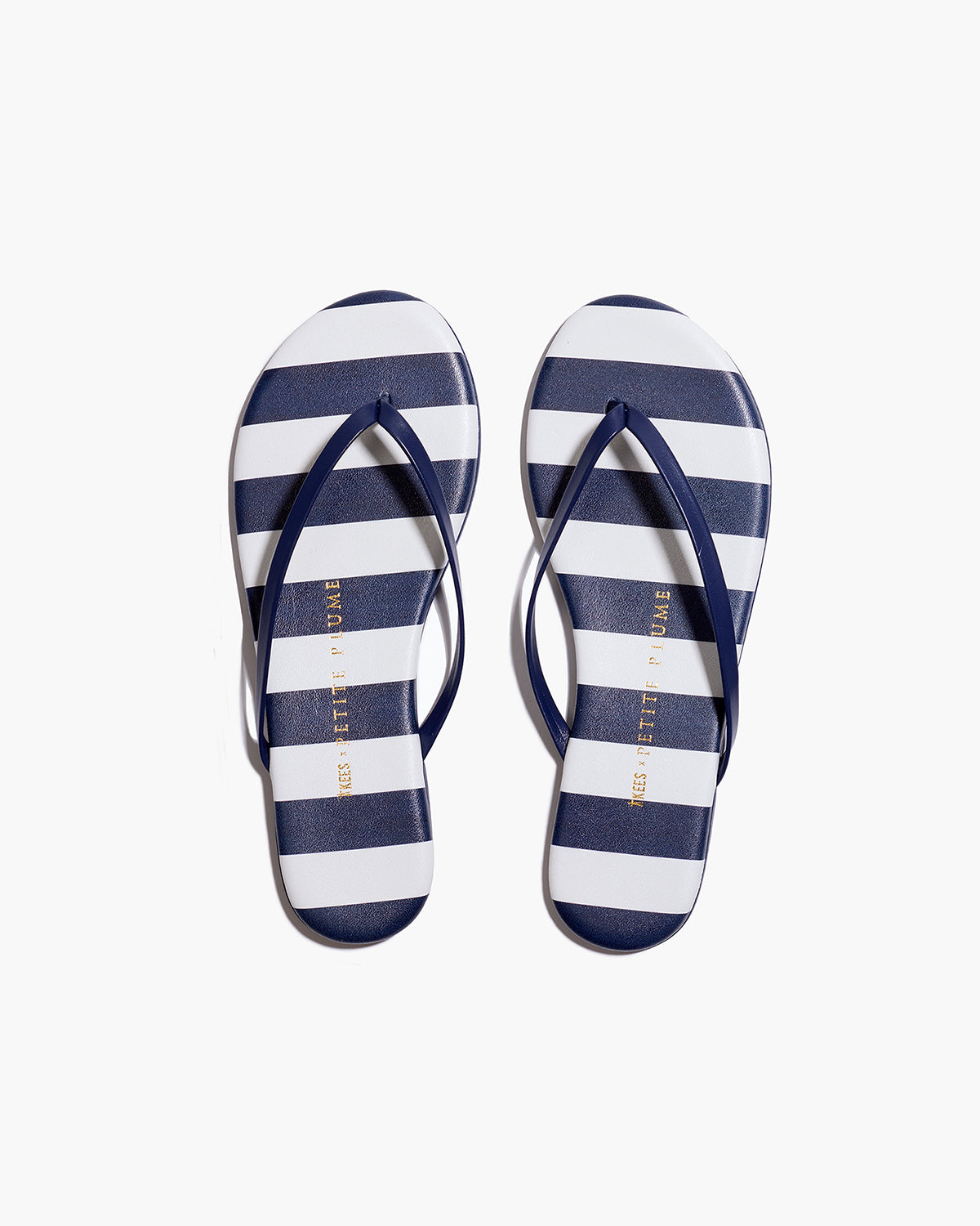 The Petite Plume x TKEES Lily Sandal in Cabana Stripe features navy blue and white horizontal stripes on the footbed with navy straps, shown side by side on a white background.