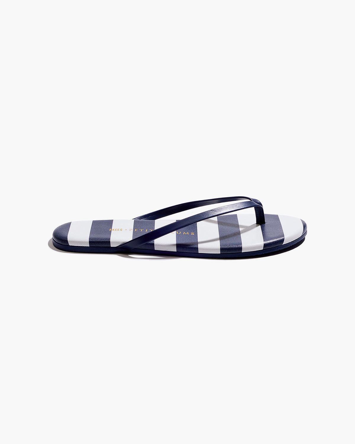 The Petite Plume x TKEES Lily Sandal in Cabana Stripe features navy blue and white horizontal stripes on the footbed with navy straps, shown side by side on a white background.
