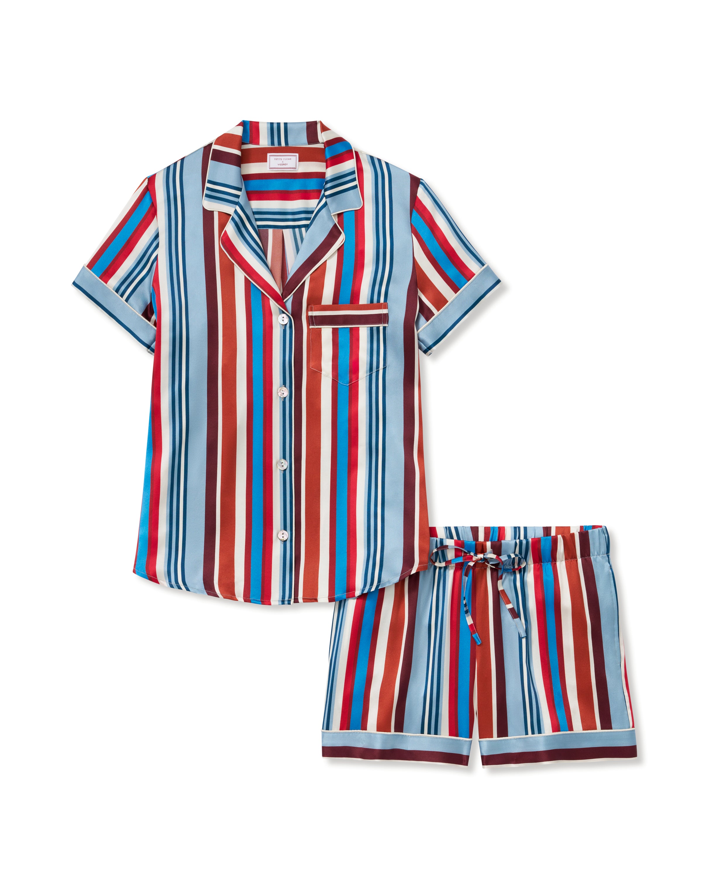 The Women's Silk Short Set in Discovery Stripe features a short-sleeved button-up shirt and matching drawstring shorts with bold vertical stripes in red, blue, brown, and white.