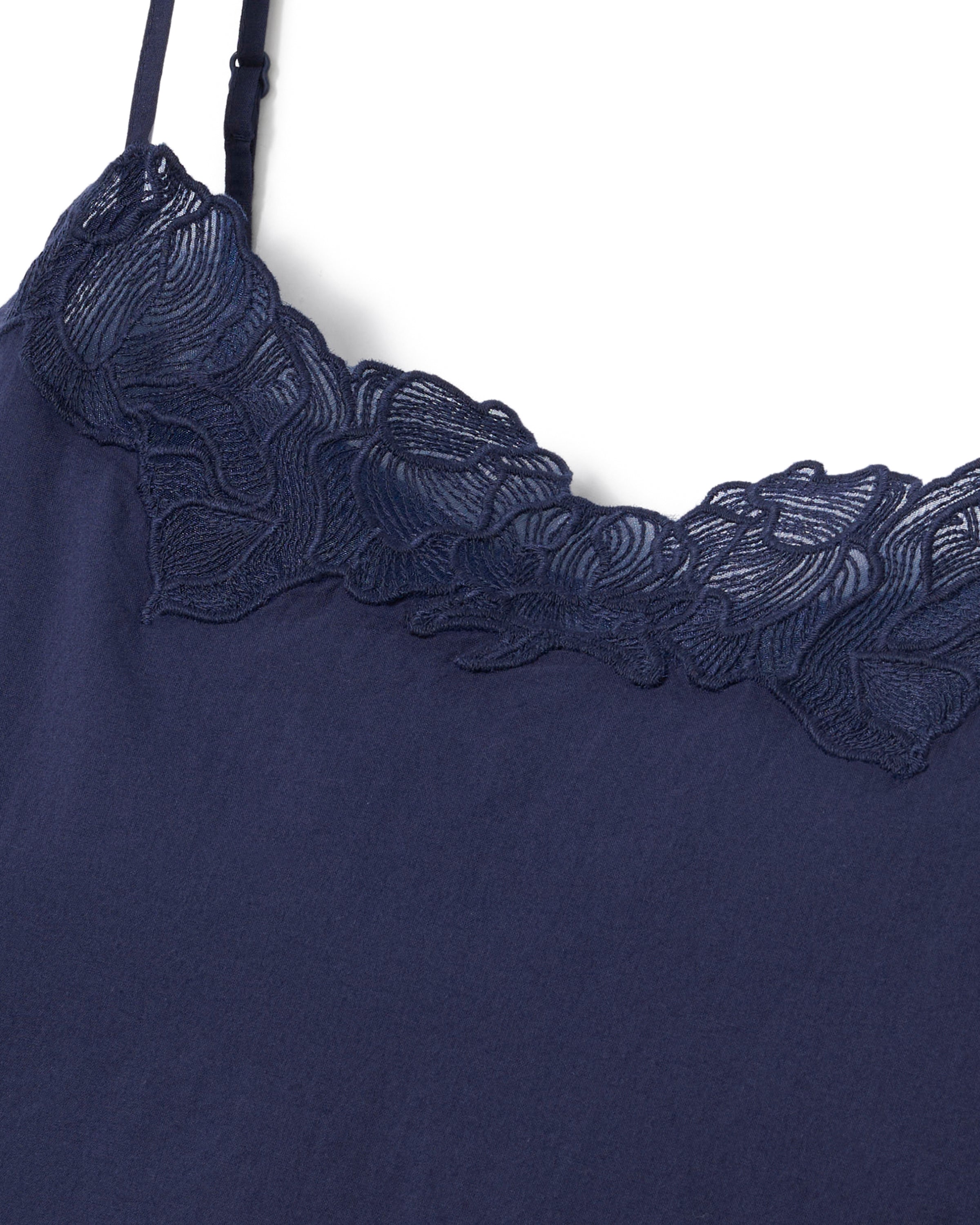 A woman stands barefoot against a plain light background, wearing the Women's Voile Fleur Cami Pant Set in Navy.