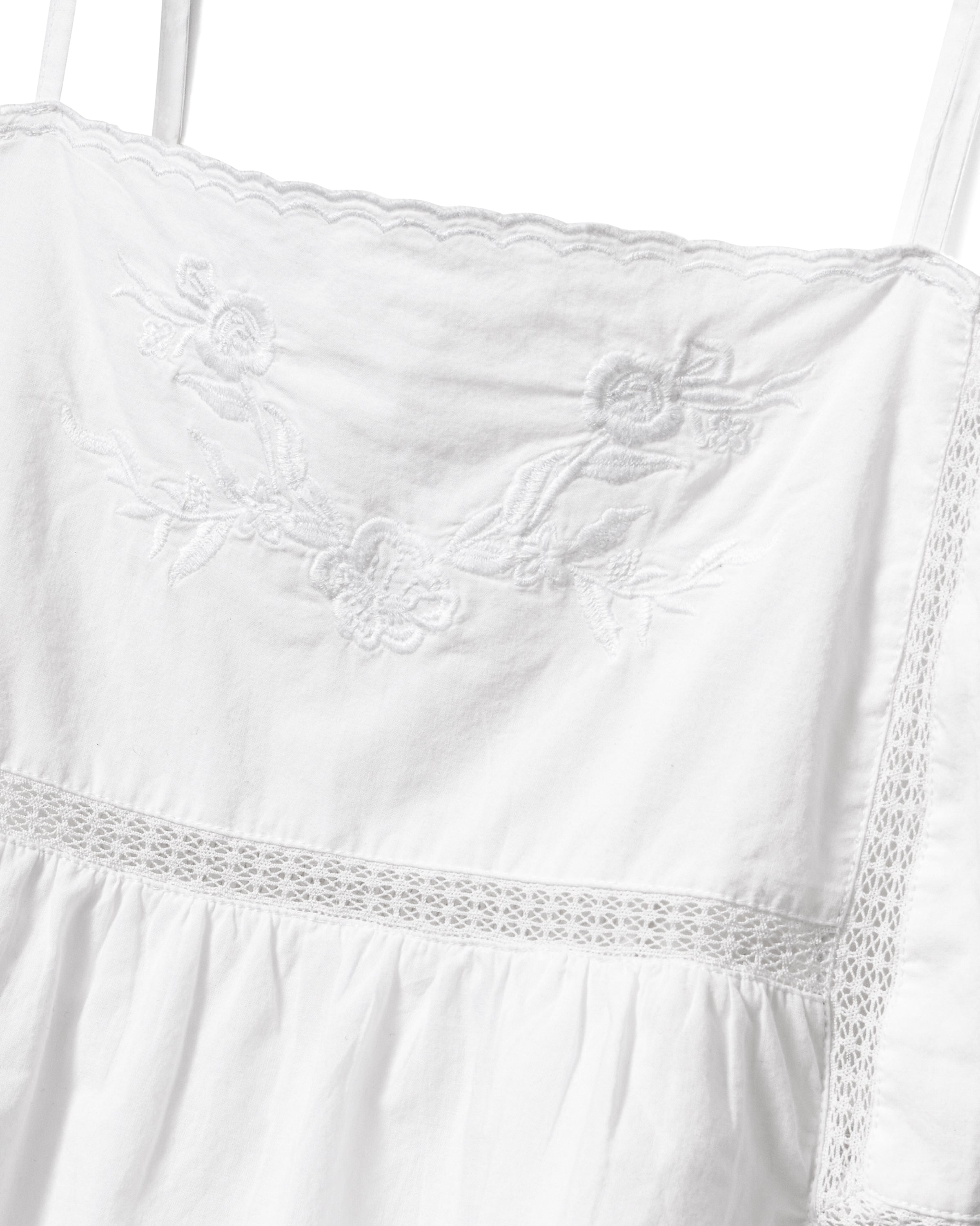 A woman with wavy, light brown hair wears the Women's Voile Luna Cami Short Set in White, standing against a plain light background.