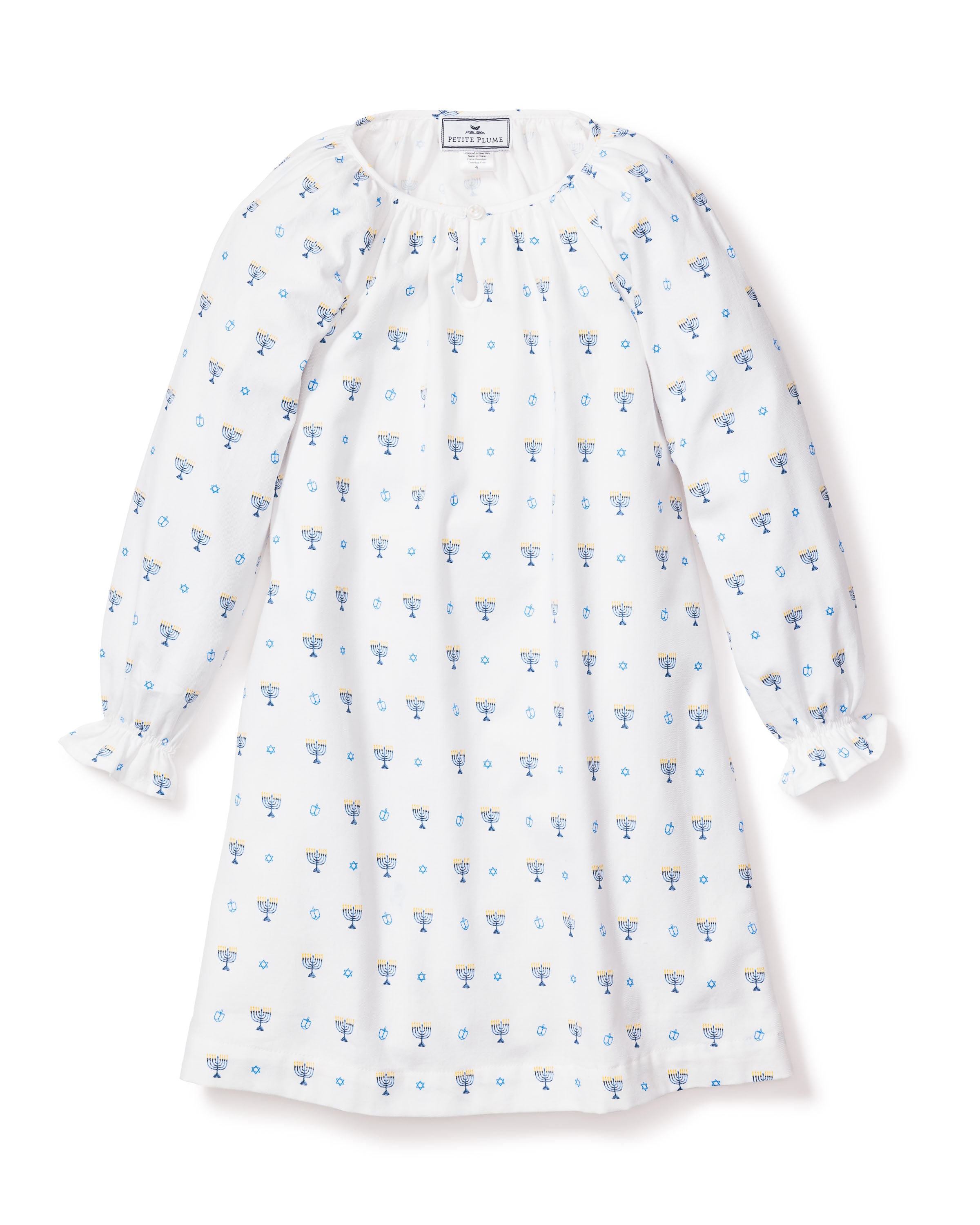 The Petite Plume Girls Twill Delphine Nightgown in Happy Hanukkah is a white, long-sleeved nightdress with a loose fit, gathered neckline, and small blue floral designs. Its part of our childrens sleepwear collection and features charming ruffled cuffs on flame-retardant fabric.