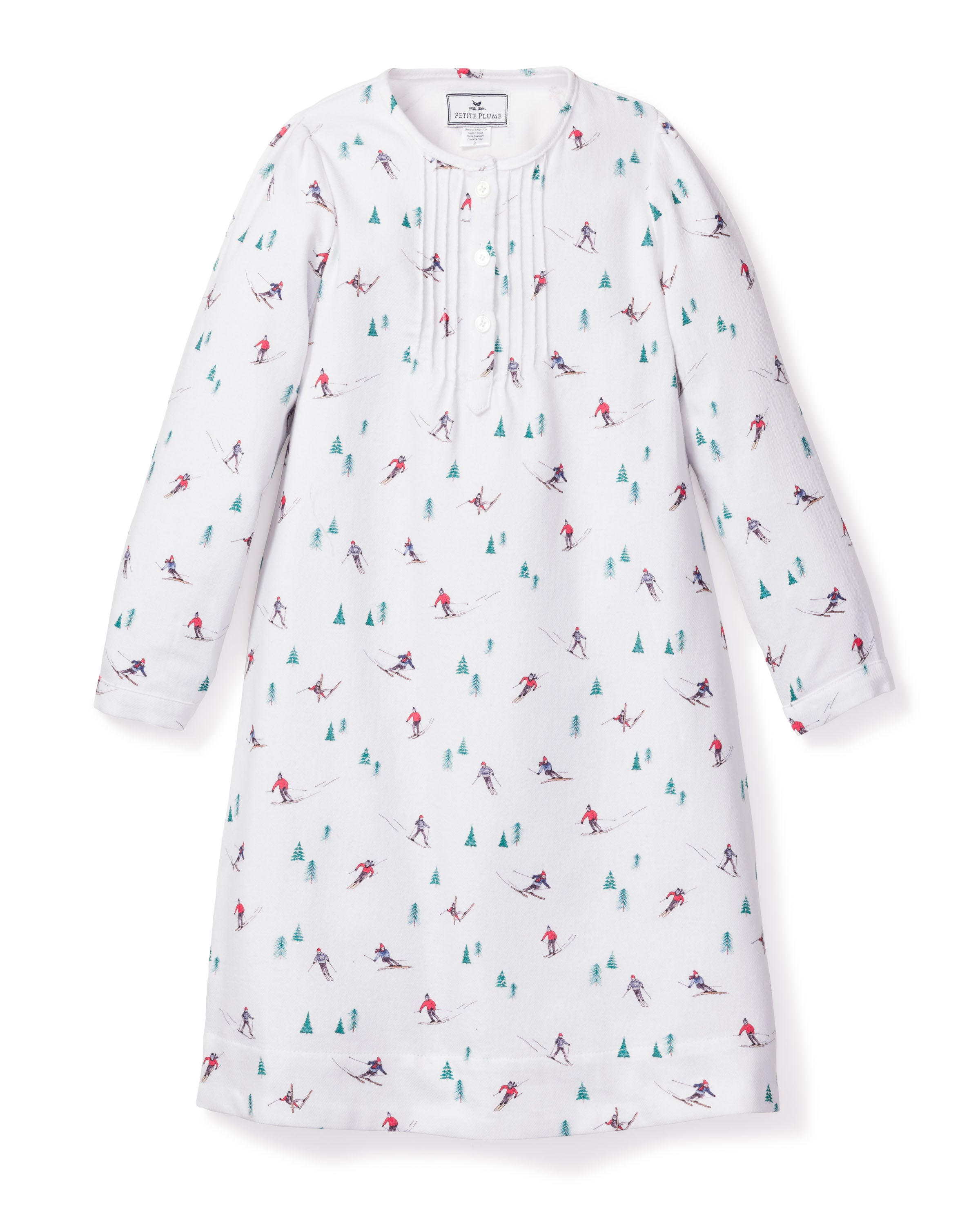 The Girls Flannel Beatrice Nightgown in Après Ski by Petite Plume is a white long-sleeve gown with a ski-themed colorful print, reminiscent of a family ski vacation, featuring a buttoned placket and round neckline for a playful winter look.