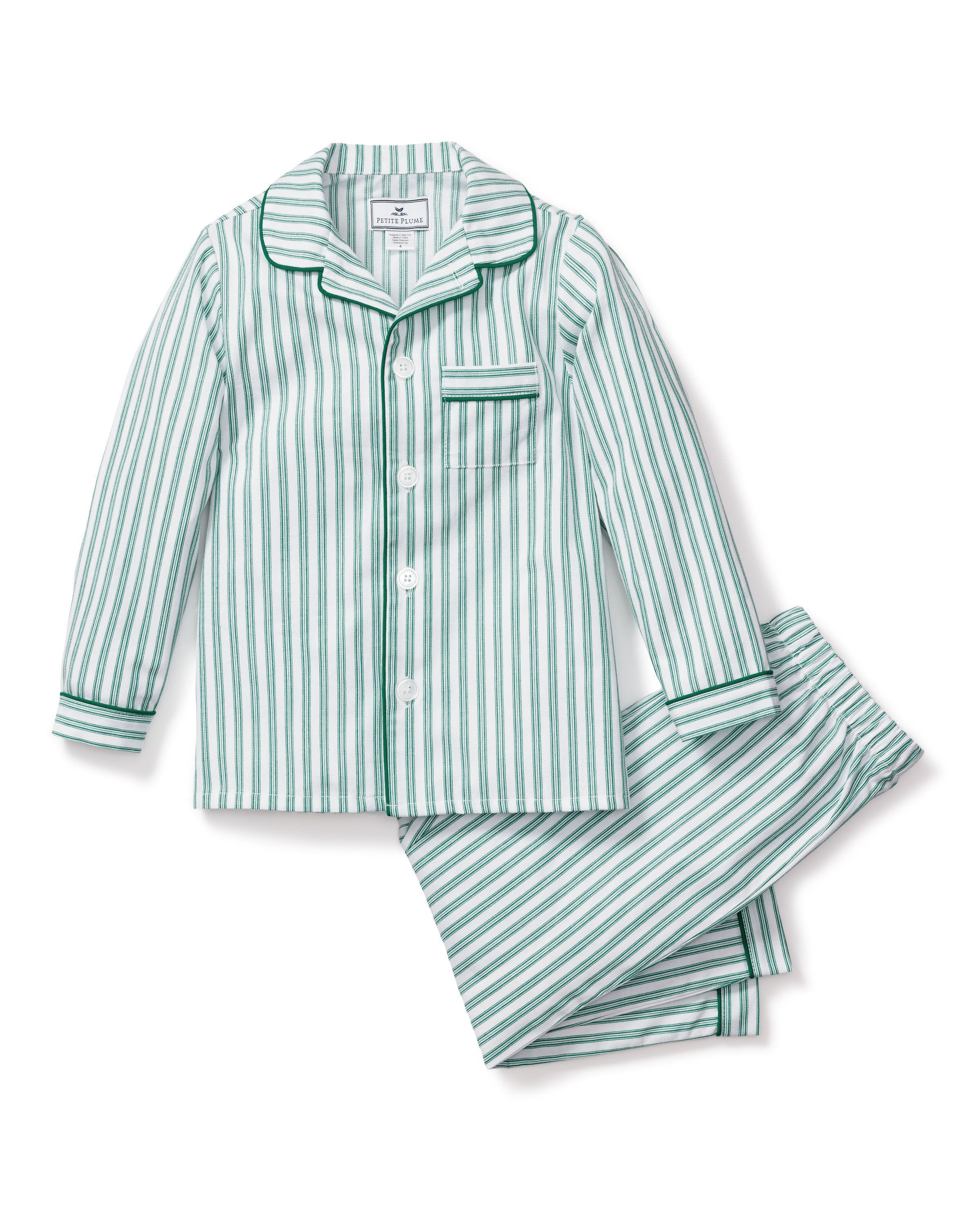 Close-up of Petite Plumes Kids Twill Pajama Set in Emerald Ticking, showcasing vertical blue and white stripes with green trim. The classic French ticking pattern includes buttons, a pocket, and visible cotton sleepwear texture and stitching details.