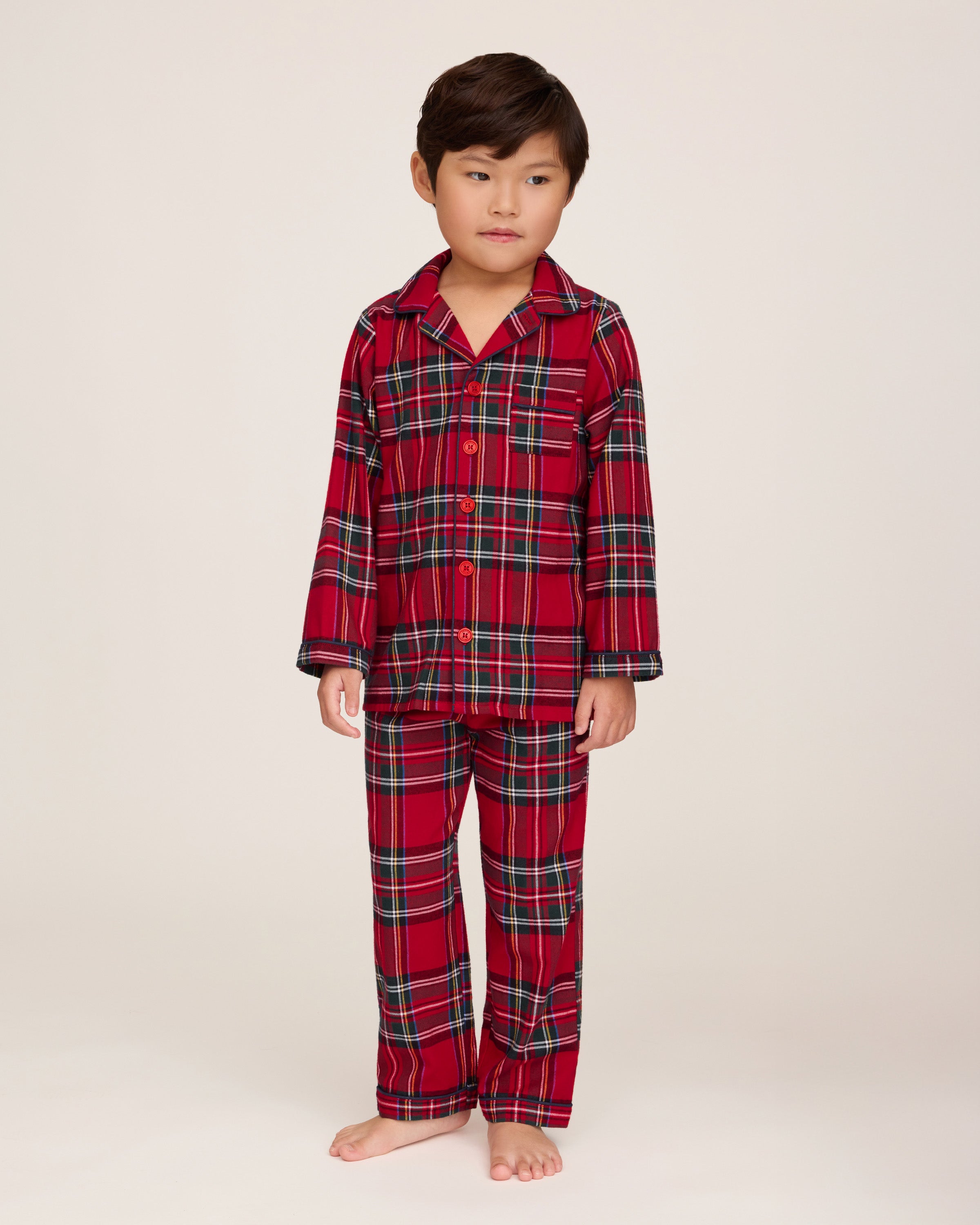 Kid's Brushed Twill Pajama Set in Imperial Tartan features a red, green, white, and black plaid design with a long-sleeve button-up top, chest pocket, collar, and matching pants.