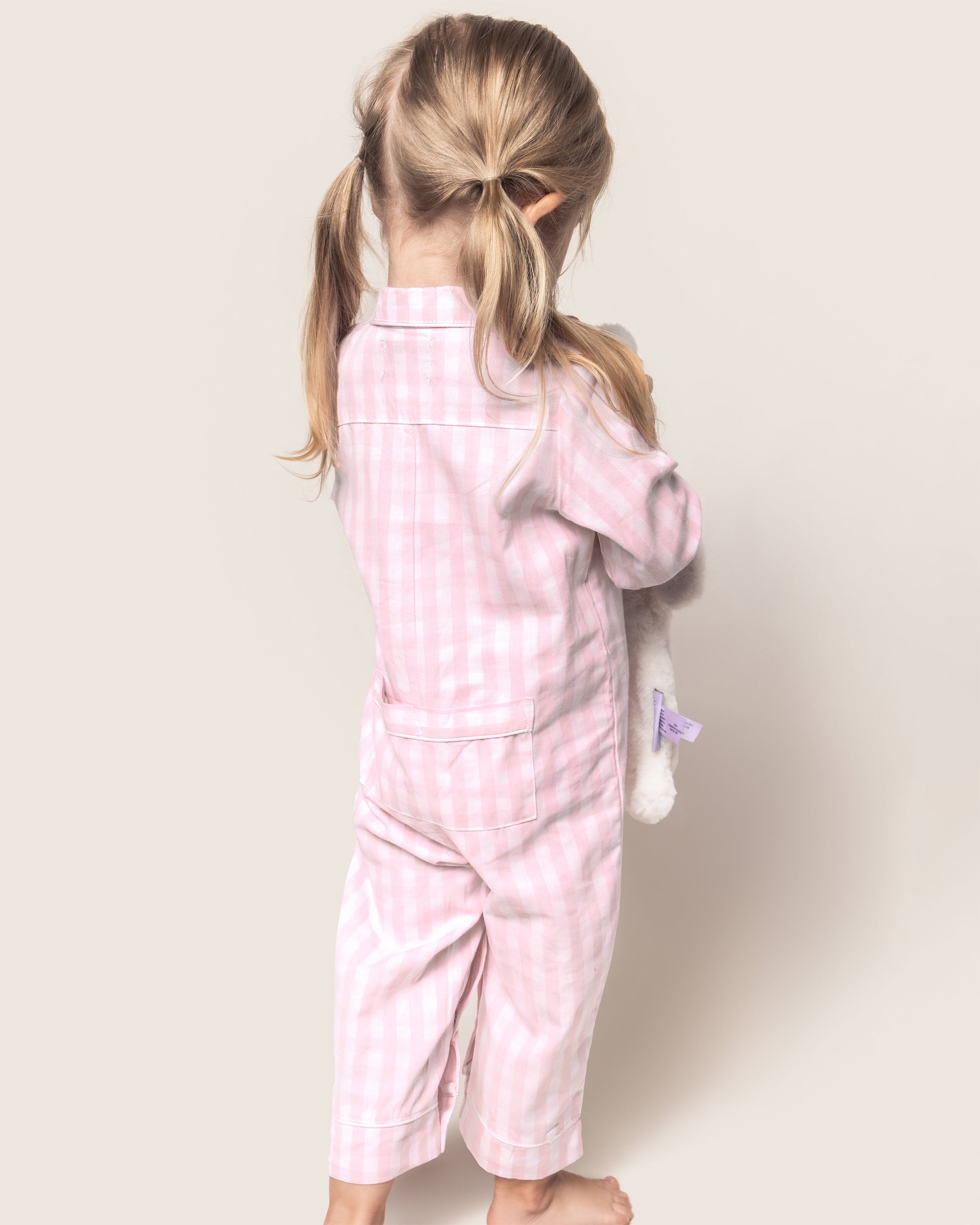 Baby's Twill Classic Romper in Pink Gingham: long sleeves, small collar, button front, footless legs. Light pink and white checkered design. Garment shown flat on a white background.