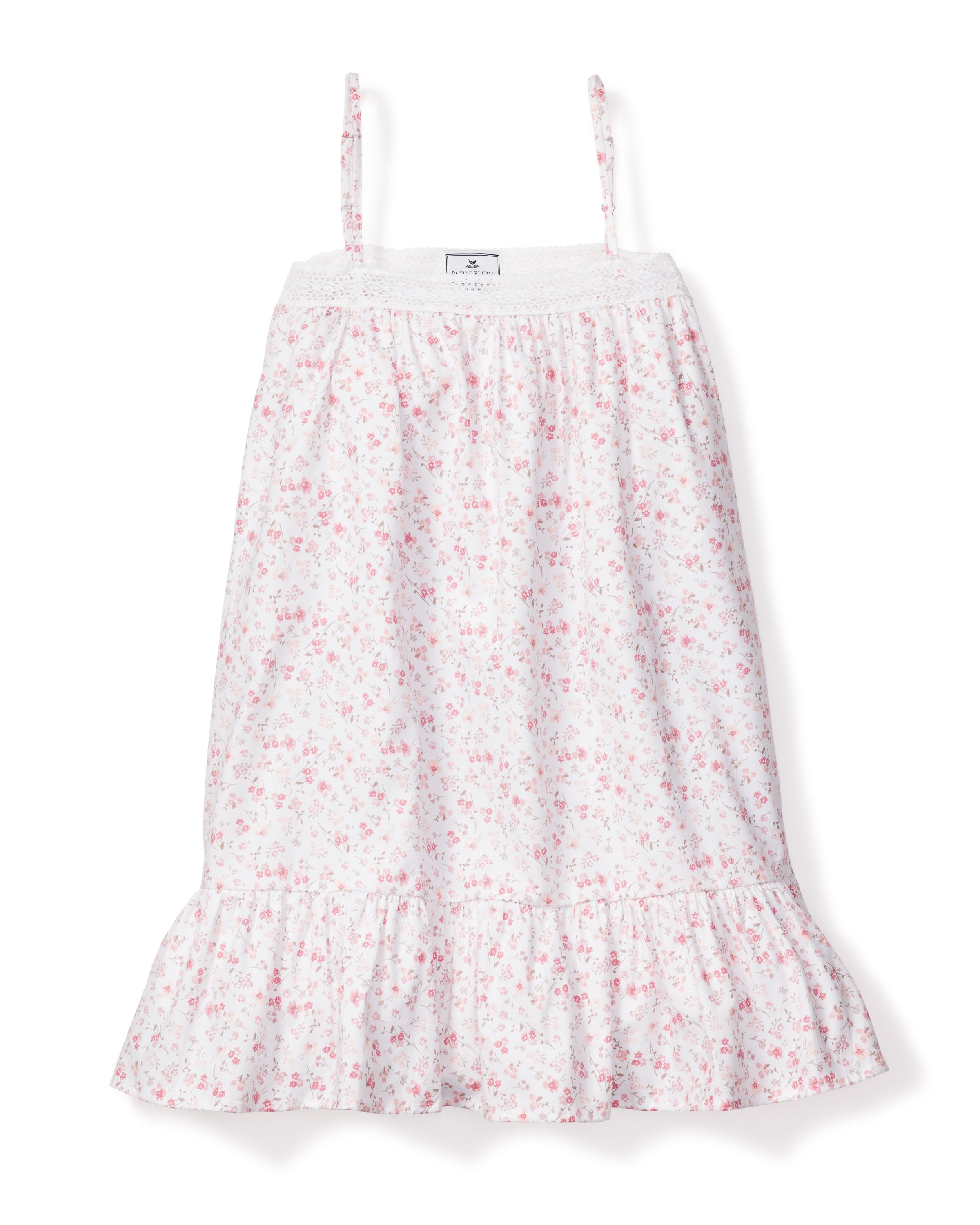 The Girls Twill Lily Nightgown in Dorset Floral by Petite Plume features a summery, sleeveless design with thin straps, a shirred bodice, and small pink floral patterns on white fabric, complete with a ruffled hem.