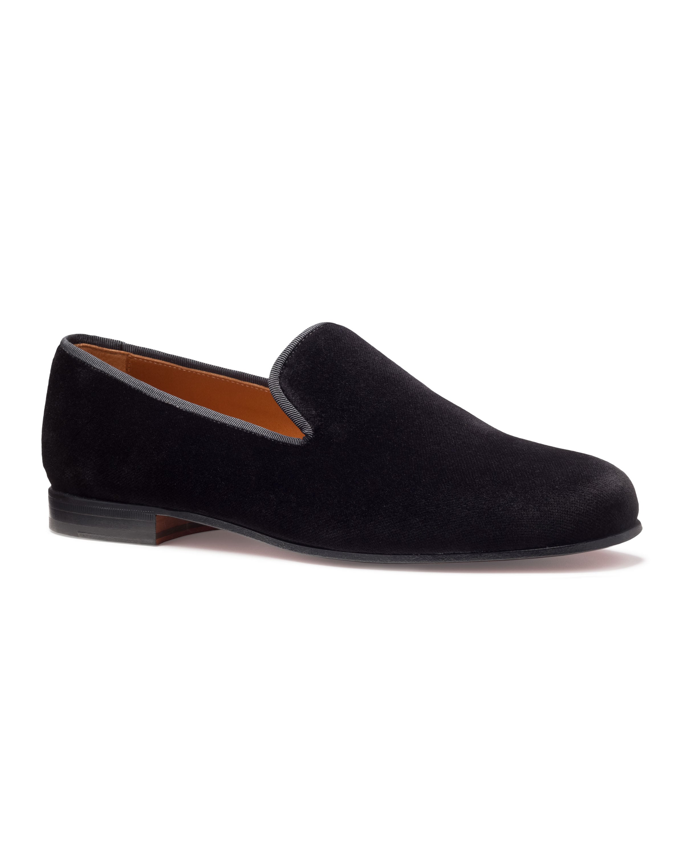 The Mens Hamptons Loafer in Black by Petite Plume features a classic silhouette and low heel, shown side view on a white background. Its refined elegance complements mens pajamas for an upscale, relaxed look.