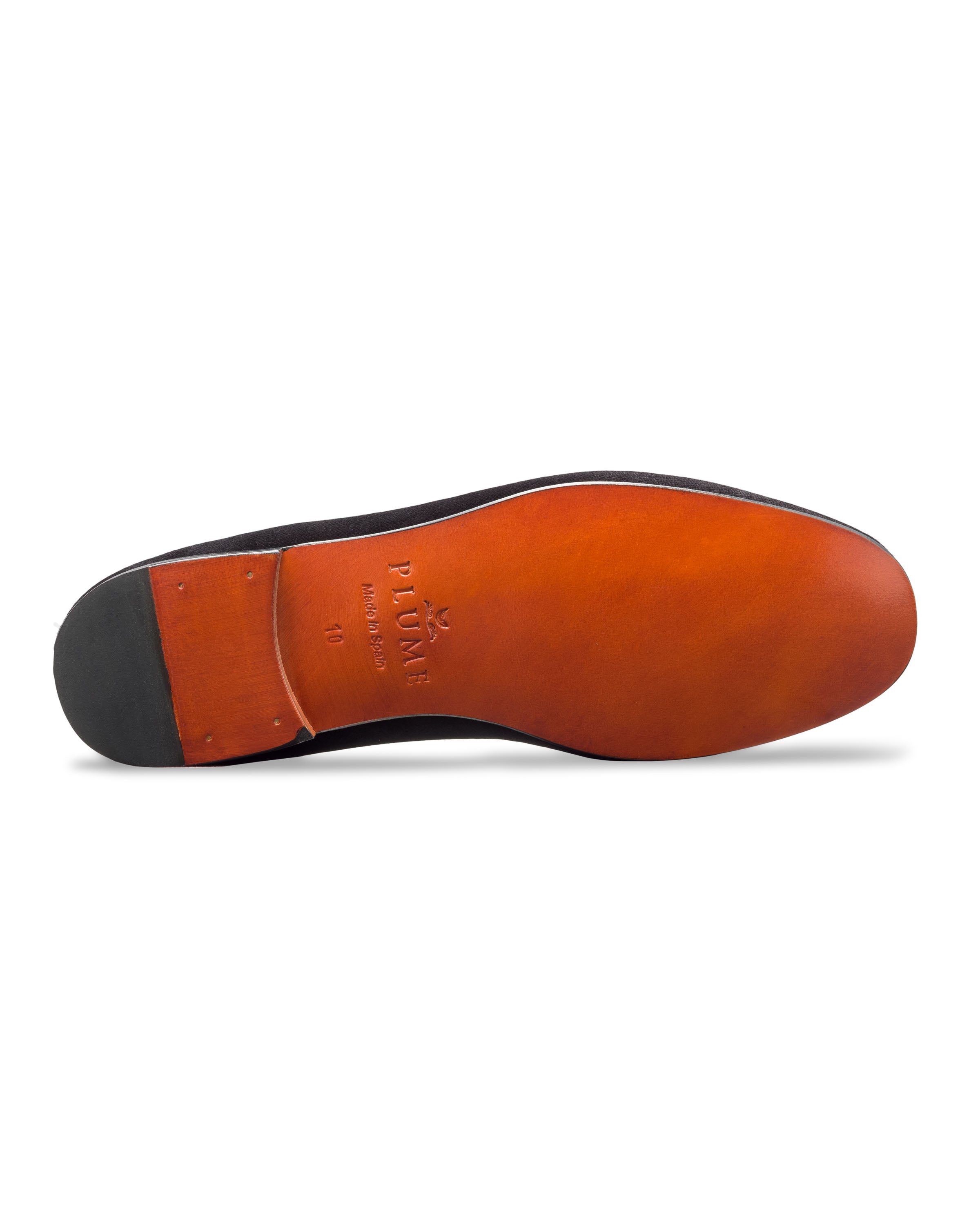 The image highlights the sole of a high-end Mens Hamptons Loafer in Black by Petite Plume. The rich brown sole with a black heel features an elegant engraving of PLUME Handmade and a decorative emblem.