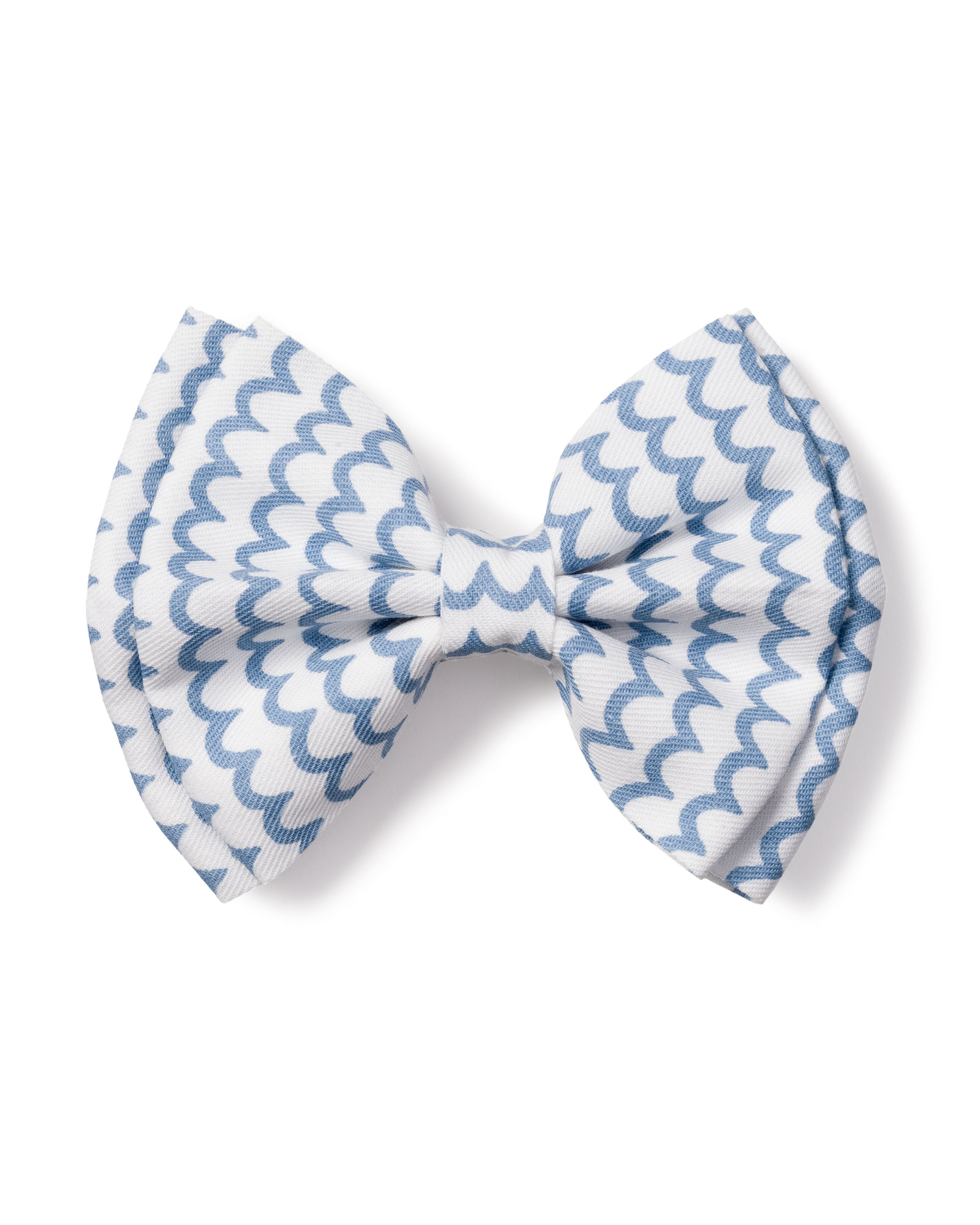 The Girls Hair Bow in La Mer by Petite Plume is a charming blue and white accessory with a wavy zigzag pattern.
