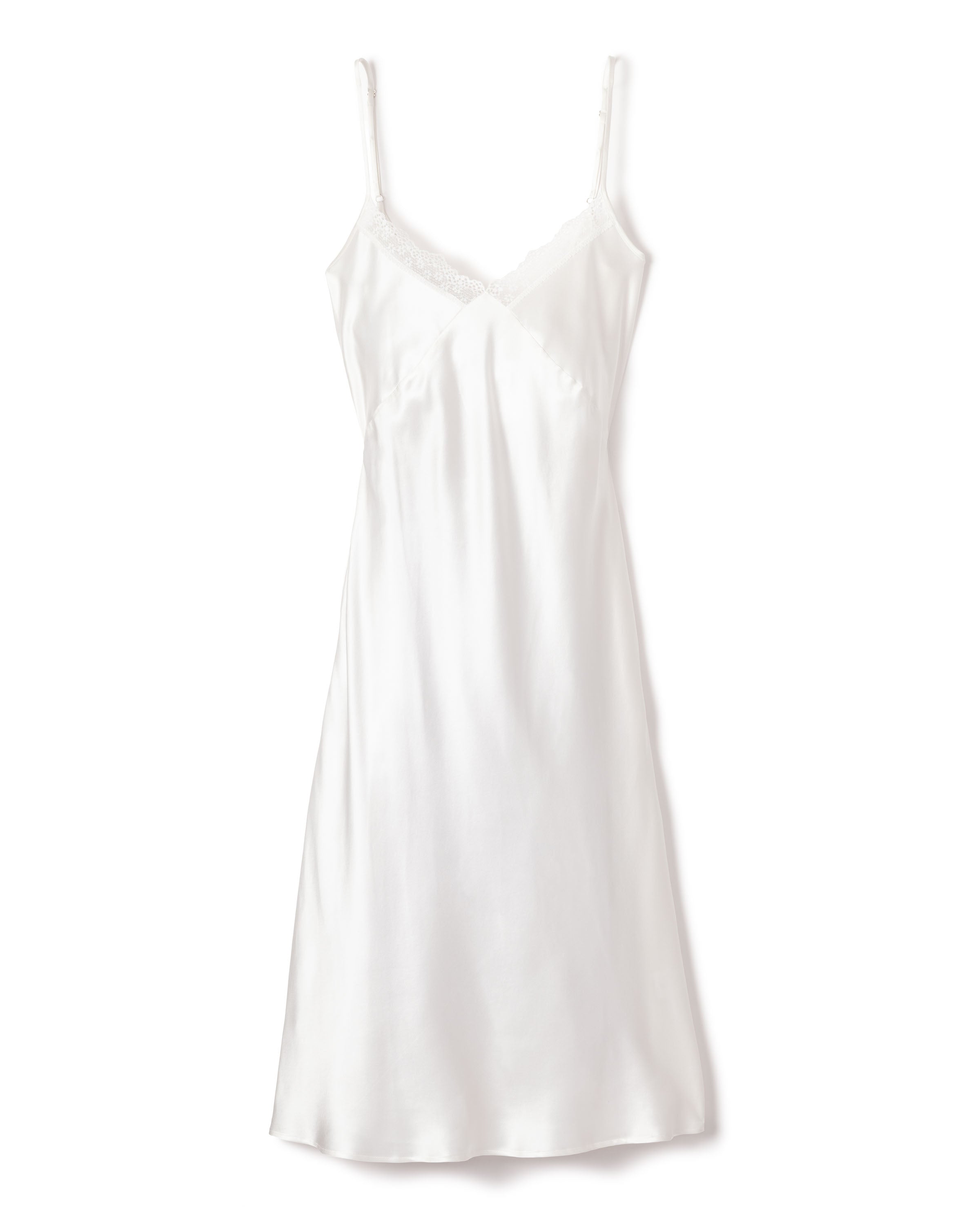 The Womens Silk Lace Cosette Nightgown in White by Petite Plume, featuring thin straps and delicate lace trim, exudes minimalist elegance with its shiny, smooth texture. This luxurious sleepwear falls just above the knee, offering both style and comfort.