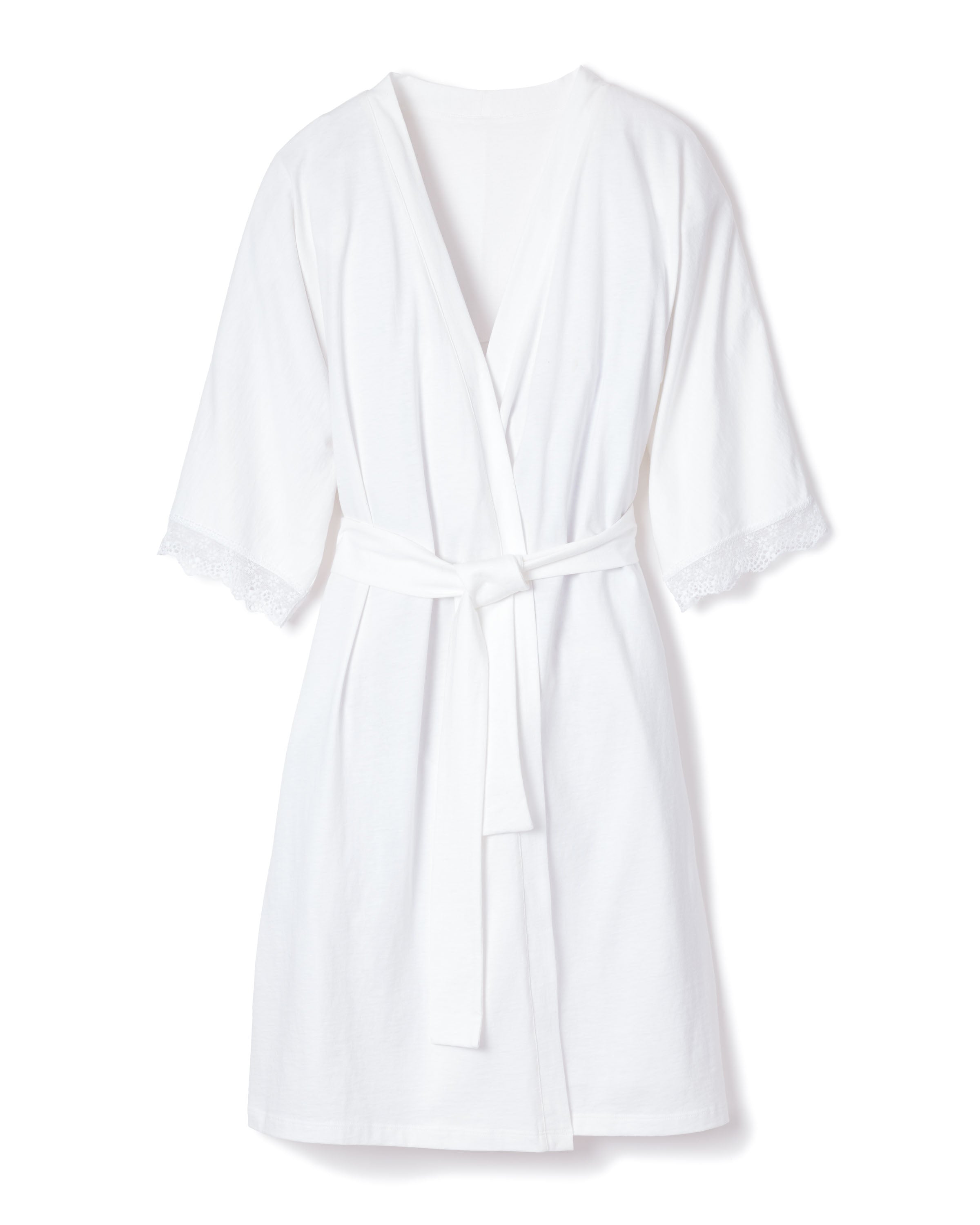 The Womens Pima Robe with Lace in White by Petite Plume features luxurious Peruvian Pima cotton, three-quarter sleeves, a tie belt, and lace detailing at the sleeve edges. Ideal for bedtime rituals, it lays flat against a white background.
