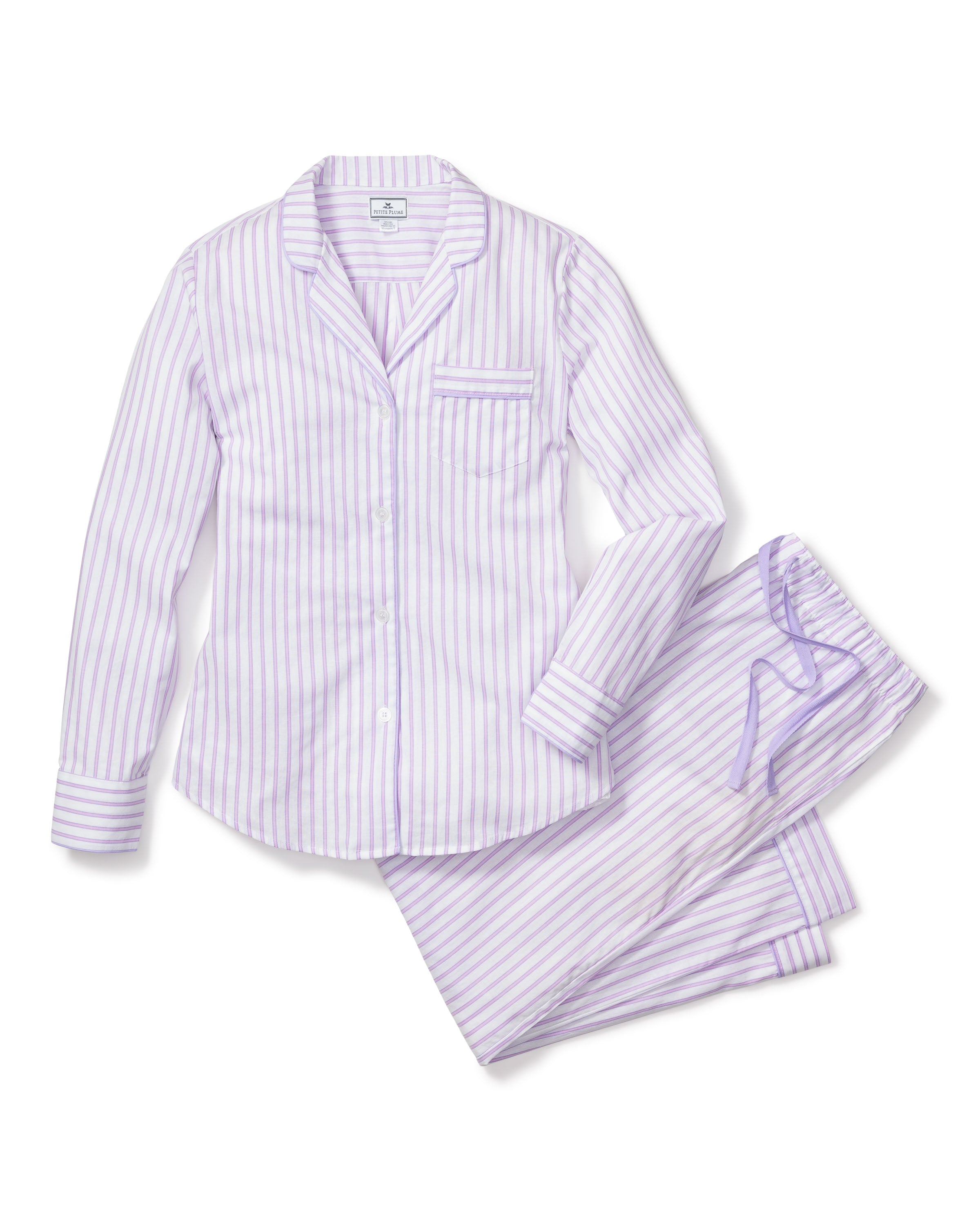 The Womens Twill Pajama Set in Lavender French Ticking by Petite Plume includes a long-sleeve button-up top with a chic chest pocket and collar, and drawstring pants featuring an elastic waist, all made from the finest quality cotton for ultimate comfort.