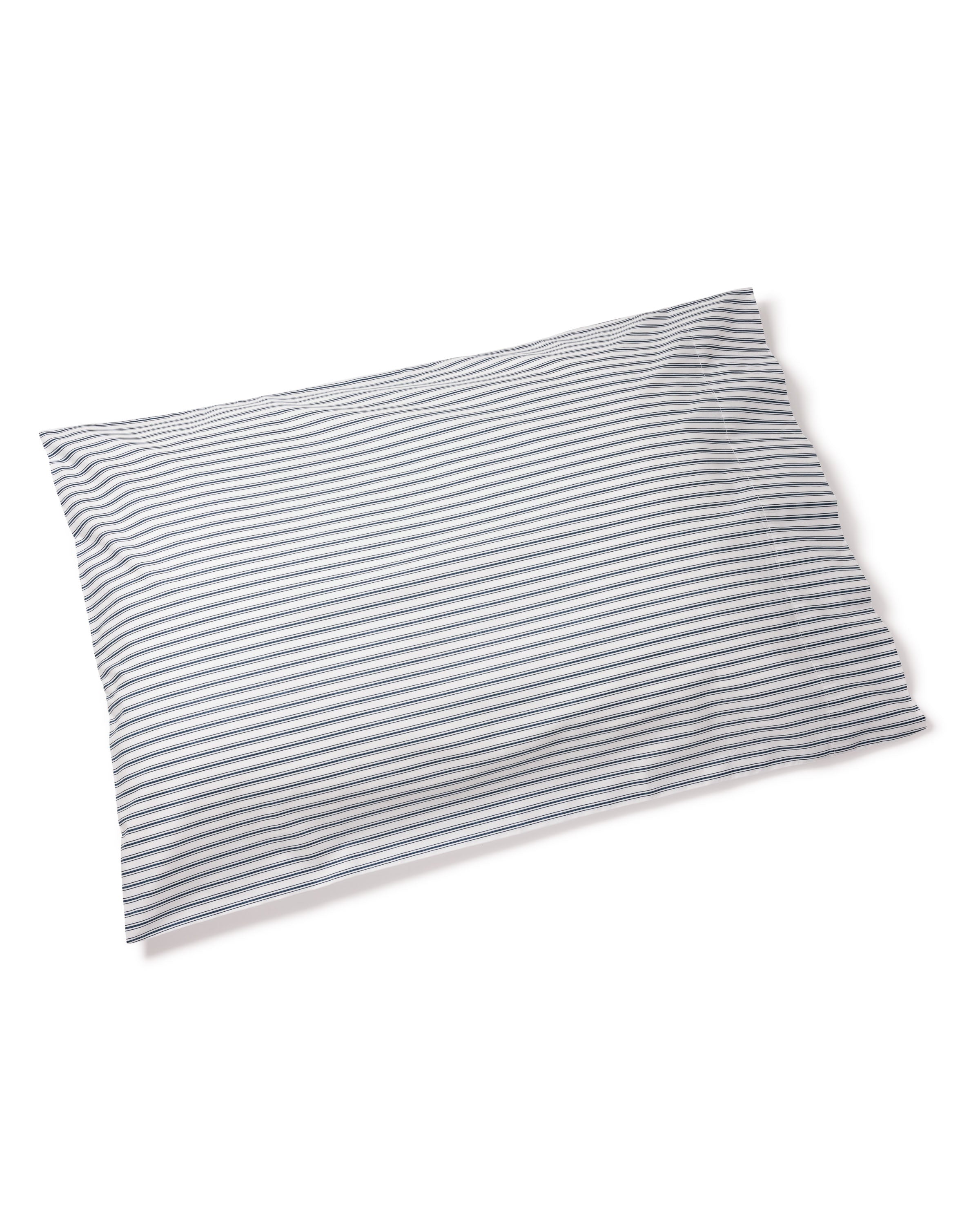Against a light backdrop lies a rectangular pillow with thin horizontal gray stripes on white, crafted from 100% cotton. It pairs elegantly with Petite Plume’s Luxe Premium Cotton Bed Sheets in Navy French Ticking.