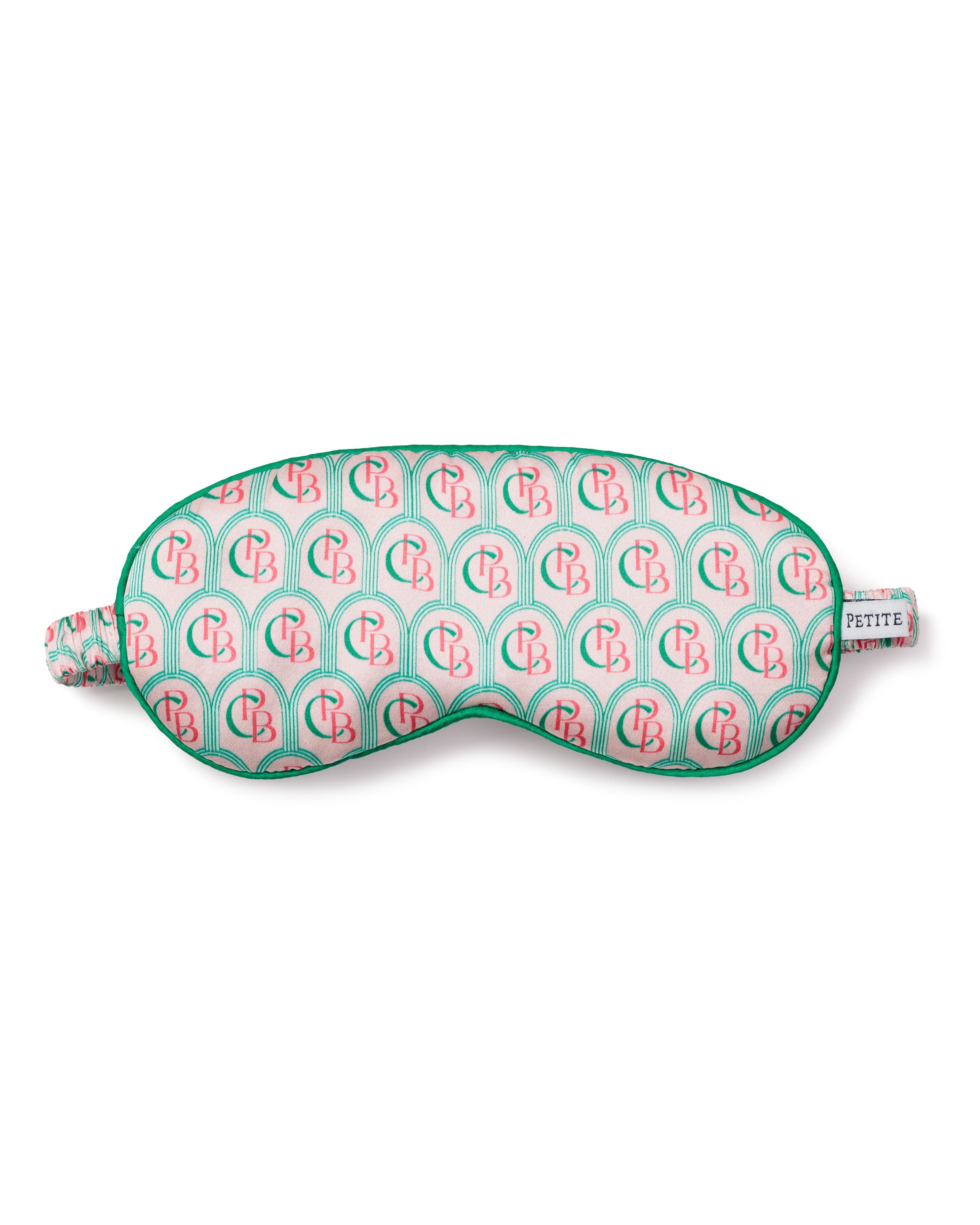 The Colony Hotel x Petite Plume Adults Silk Sleep Mask features a luxurious 22mm silk material with pink and green arches, CB initials, green trim, and an elastic band. A small side tag reads PETITE.