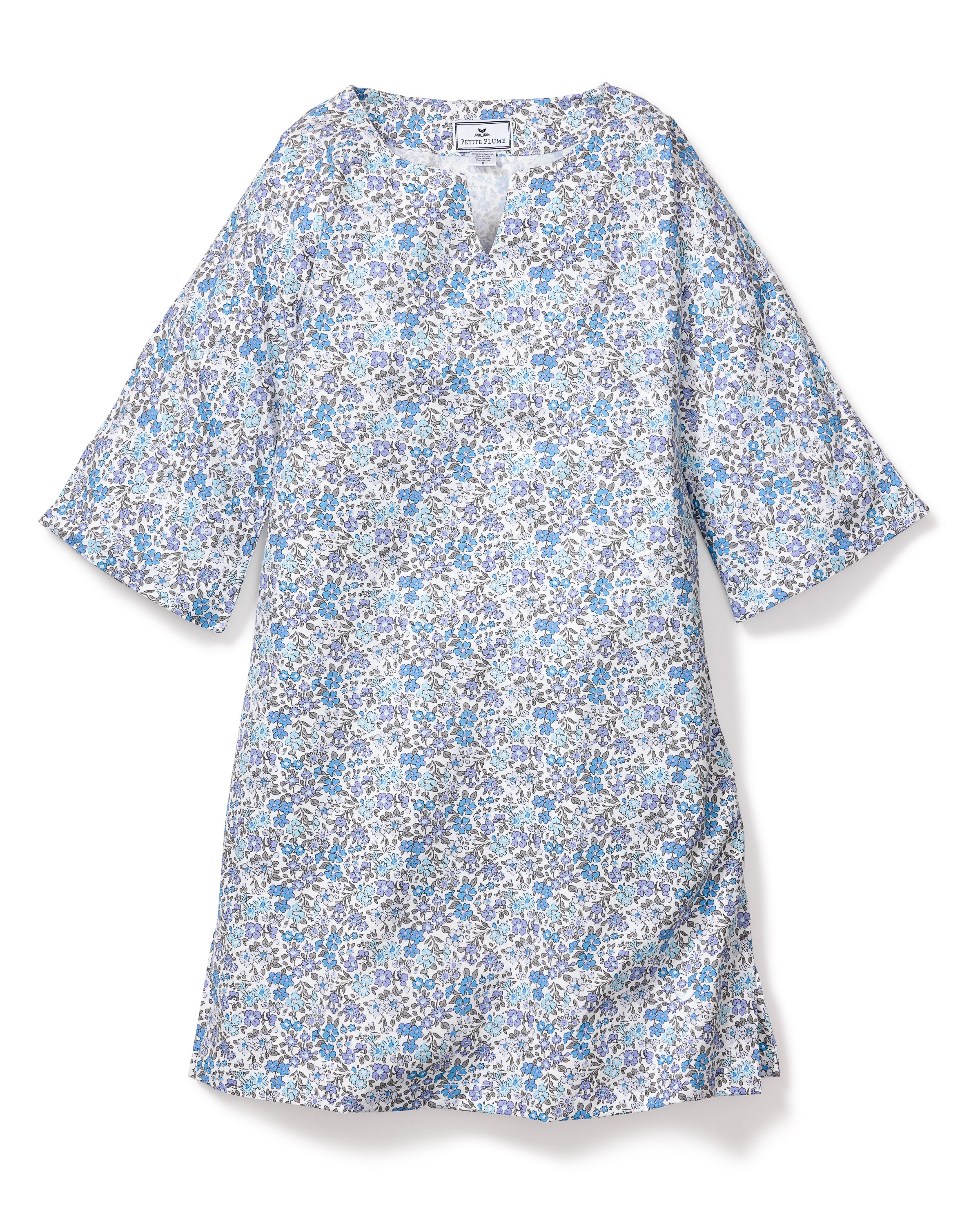 The Girls Twill Caftan in Fleur DAzur by Petite Plume is a knee-length, loose-fit dress with three-quarter sleeves. It features a vintage-inspired blue and white floral print, has a V-neckline, and is made from breathable cotton for lightweight comfort.
