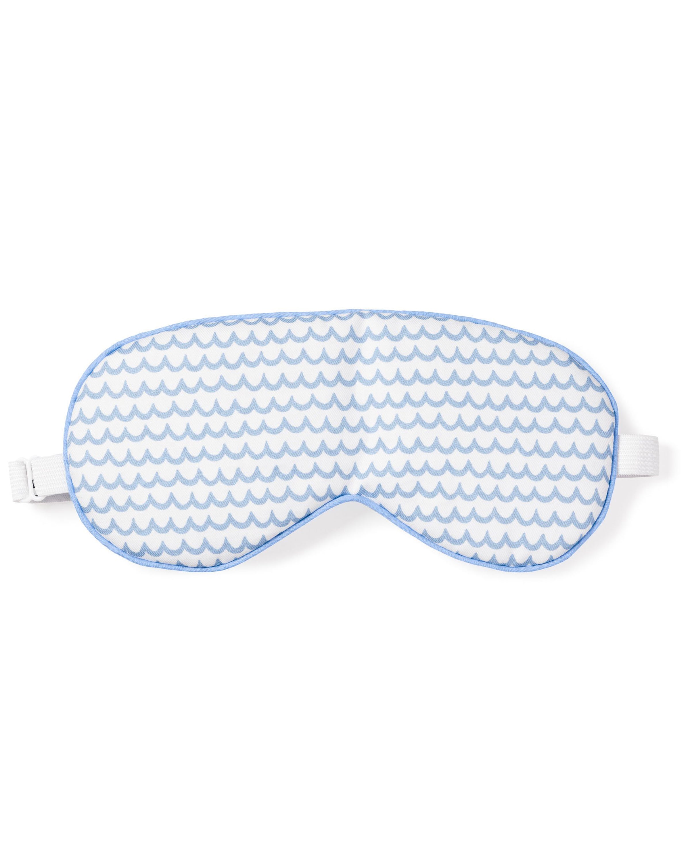 The Adults Sleep Mask in La Mer by Petite Plume features a blue and white wave pattern with an adjustable white strap. Ideal for monogrammed gifts, it offers comfort for any night-time routine.