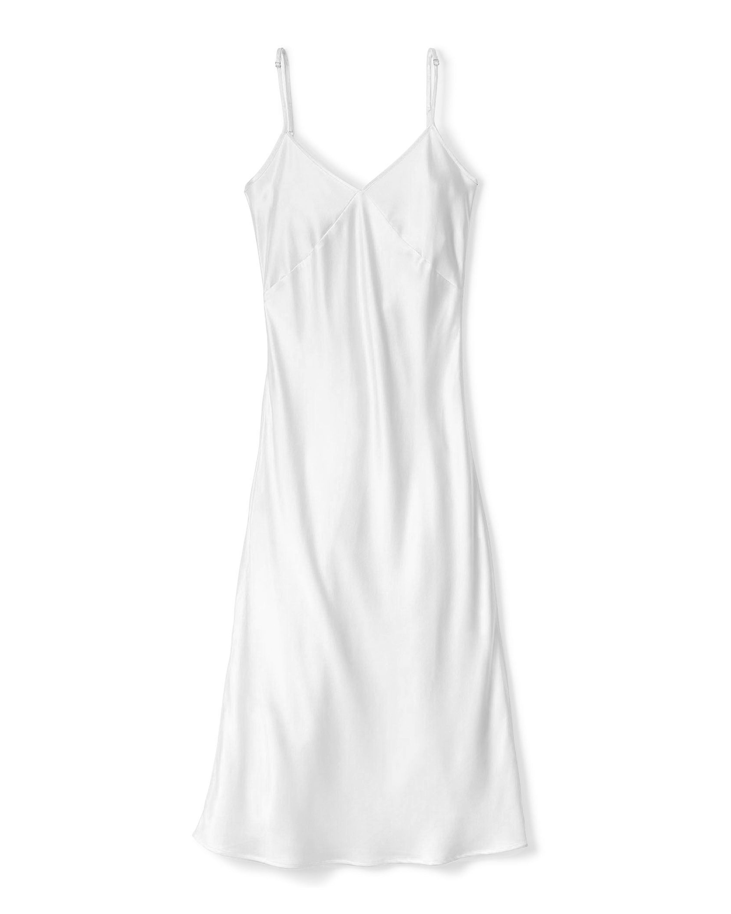 Laid flat, the Womens Silk Cosette Nightgown in White by Petite Plume features spaghetti straps and a smooth texture with a loose fit, offering minimalist elegance ideal for luxurious sleepwear.