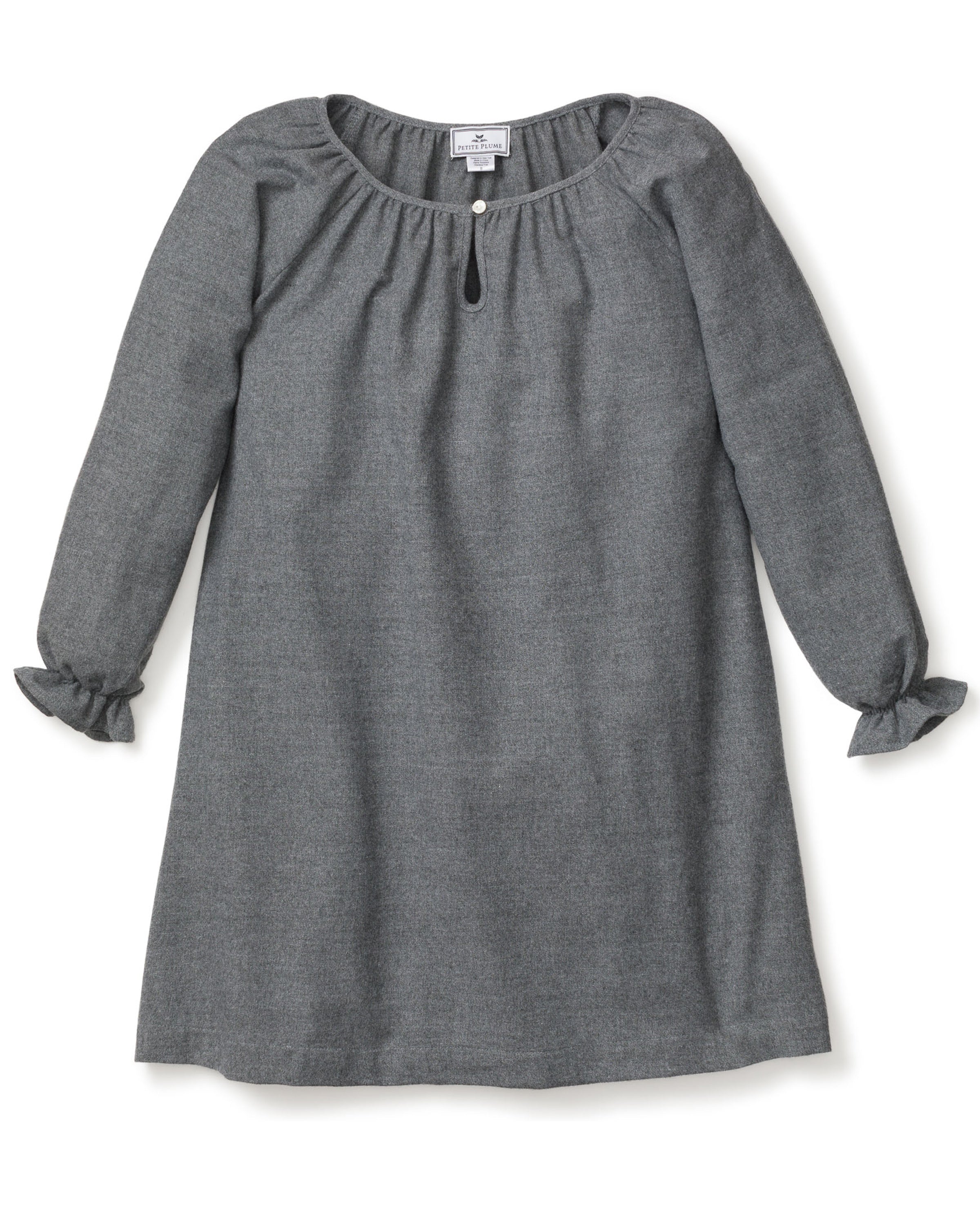 The Girls Flannel Delphine Nightgown in Grey by Petite Plume is a gray, long-sleeved nightgown with a round neckline and front keyhole detail. It features ruffled cuffs and subtly textured brushed cotton flannel, making it perfect for cozy nights as chemical-free sleepwear.