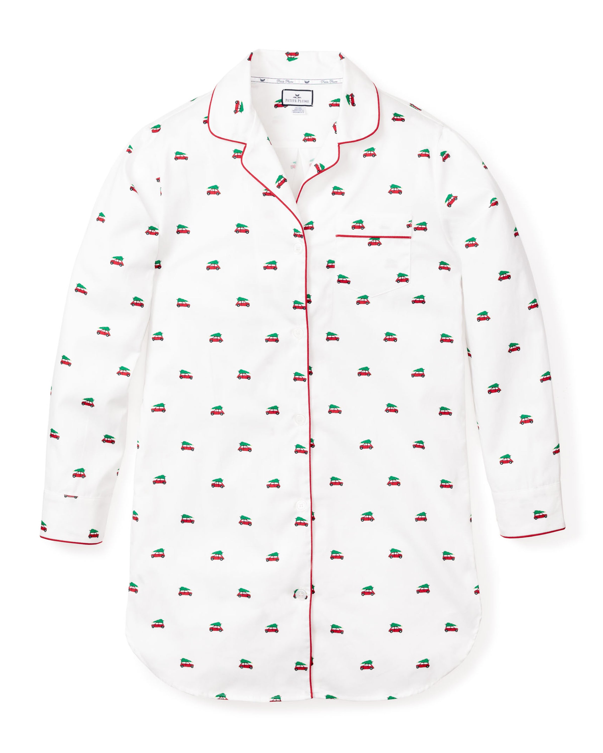 The Womens Twill Nightshirt in Holiday Journey by Petite Plume is a white nightshirt made from 100% cotton twill, with red piping and embroidered small car patterns. It features a button-down front, a single chest pocket, and a curved hem for added charm.
