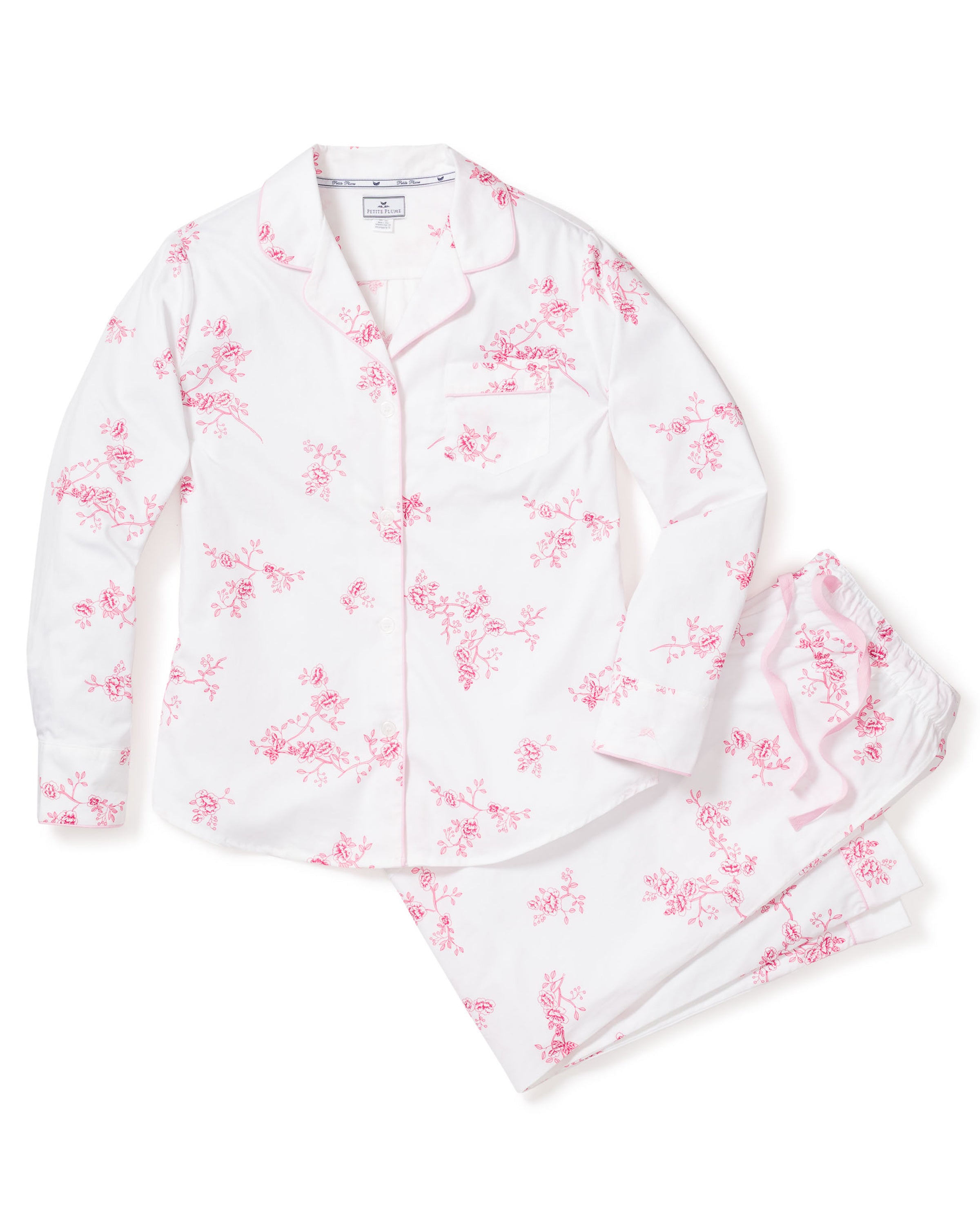 The Womens Twill Pajama Set in English Rose Floral by Petite Plume is a classic ensemble crafted from high-quality cotton. It includes a vintage pink floral long-sleeved, button-up top with a collar and chest pocket, and matching pants with an elastic waistband for comfort.