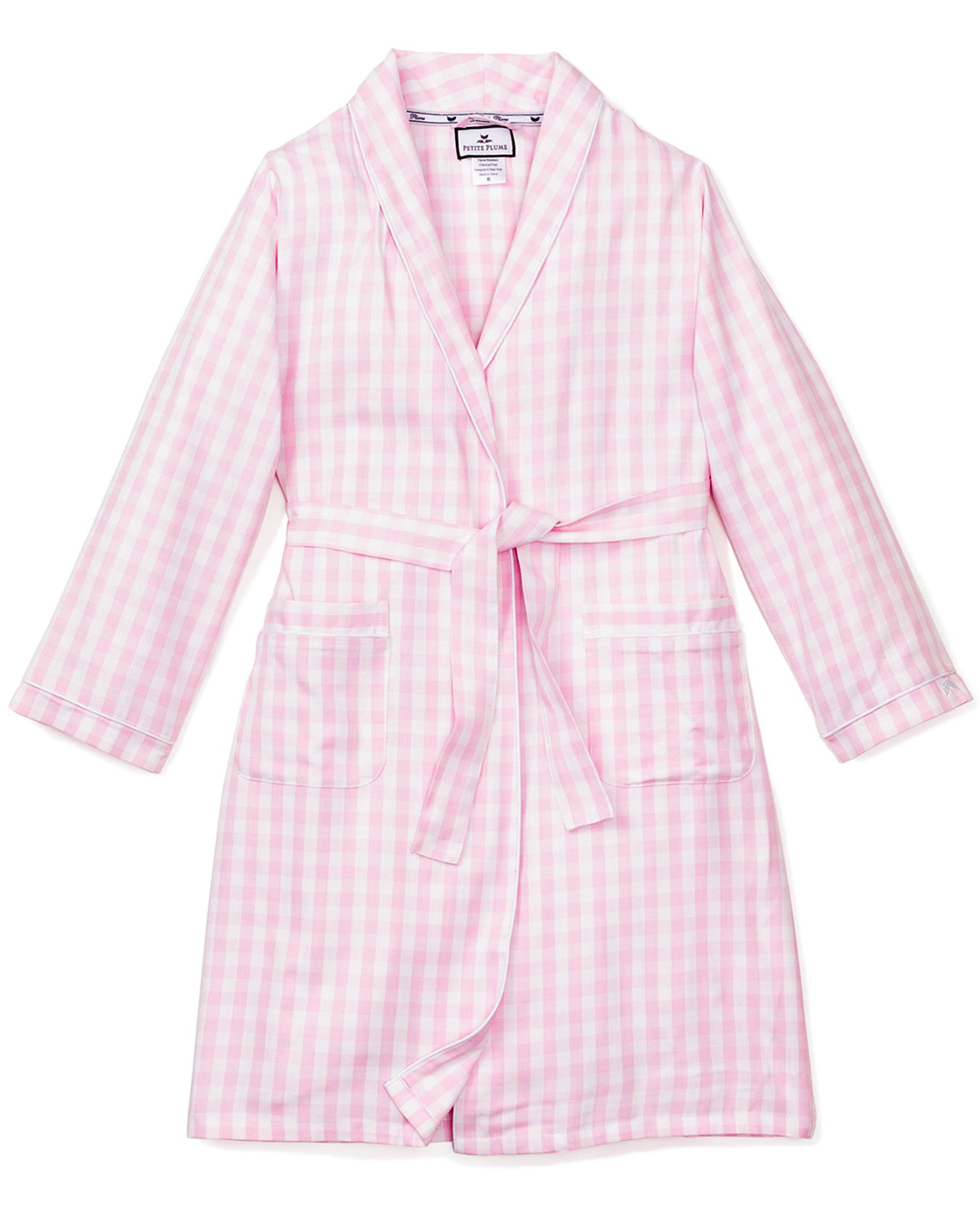 The Kids Twill Robe in Pink Gingham by Petite Plume is a flame-retardant bathrobe featuring long sleeves, a waist tie, a shawl collar, and two front pockets. Its soft material makes it ideal childrens sleepwear for lounging.