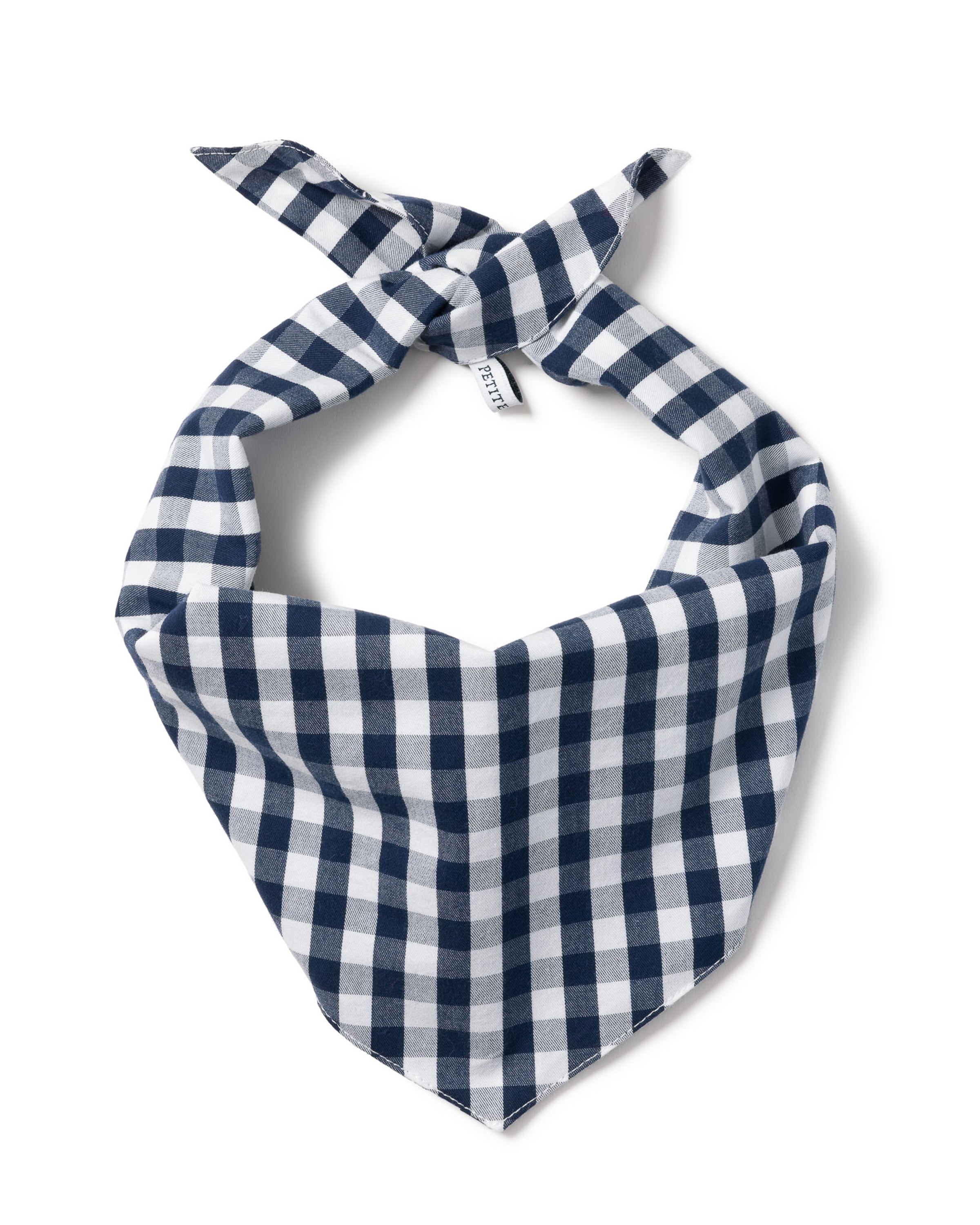 The Petite Plume Dog Bandana in Navy Gingham boasts a charming checkered pattern with evenly spaced squares on a white backdrop, tied at the top into a neat triangle—ideal for stylish pups. Small tags adorn the knot, complementing the classic gingham design.
