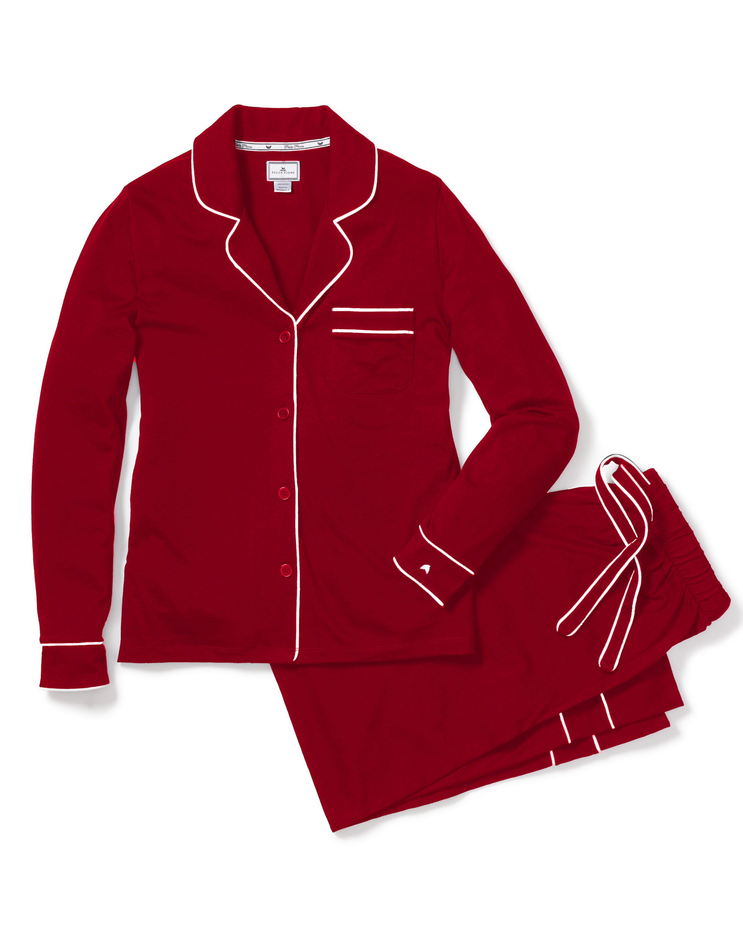 Experience luxury sleepwear with Petite Plumes Womens Pima Astaire Pajama Set in Bordeaux, made from buttery breathable Peruvian Pima cotton. It features a button-up long-sleeve top with a collar, chest pocket, elegant white piping, and matching pants with a drawstring waist and piped pockets.