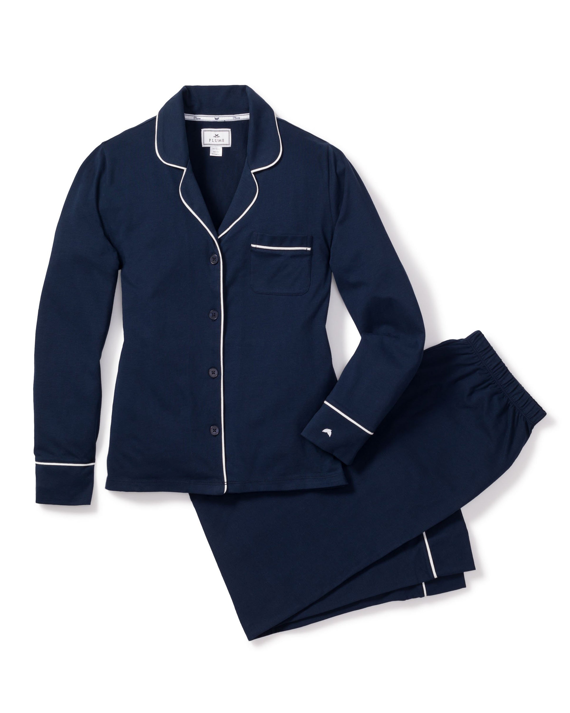 The Womens Pima Pajama Set by Petite Plume, in navy luxury sleepwear style, features white piping. This plus-size set includes a soft Pima cotton long-sleeve button-up top with a chest pocket and matching pants, displayed on a white background.