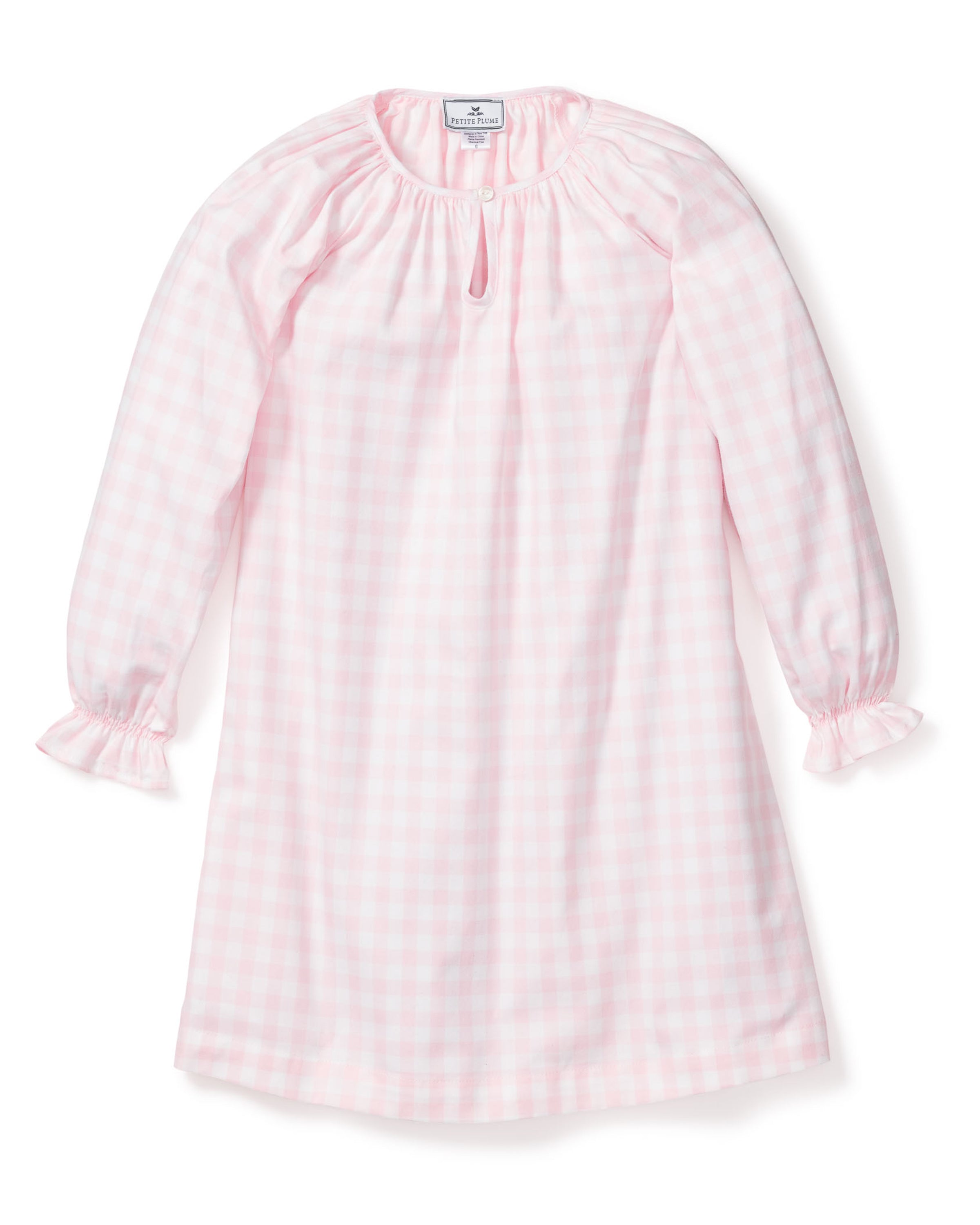 The Petite Plume Girls Twill Delphine Nightgown in Pink Gingham features long sleeves, a rounded neckline with a small keyhole opening, and ruffled cuffs, made from flame-retardant fabric.