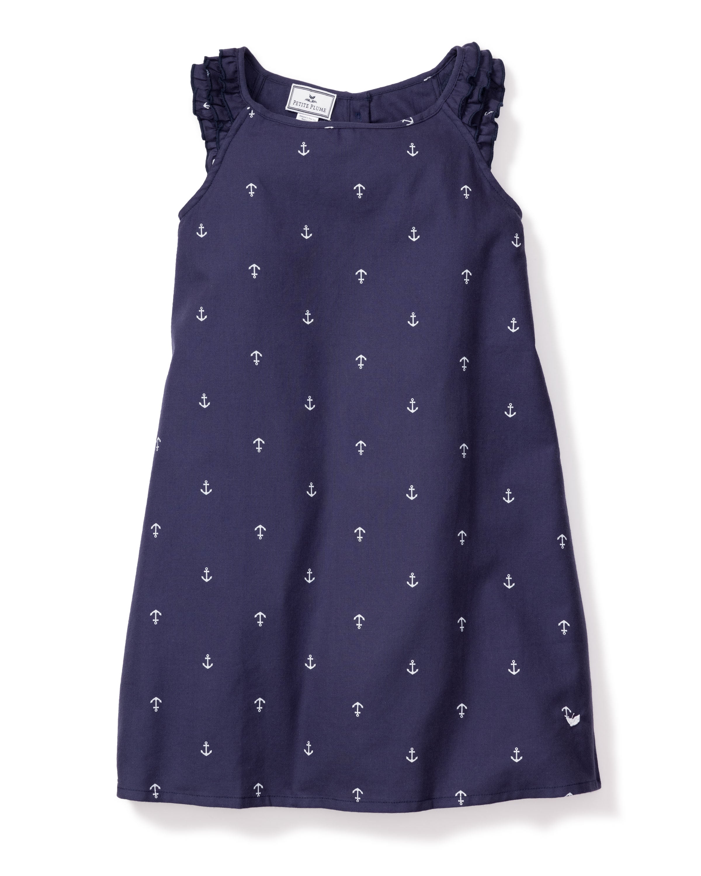 The Girls Amelie Nightgown in Portsmouth Anchors by Petite Plume is a navy blue sleeveless dress made from lightweight cotton, featuring a charming anchors print, ruffled shoulder straps, and a delicate bow at the neckline.