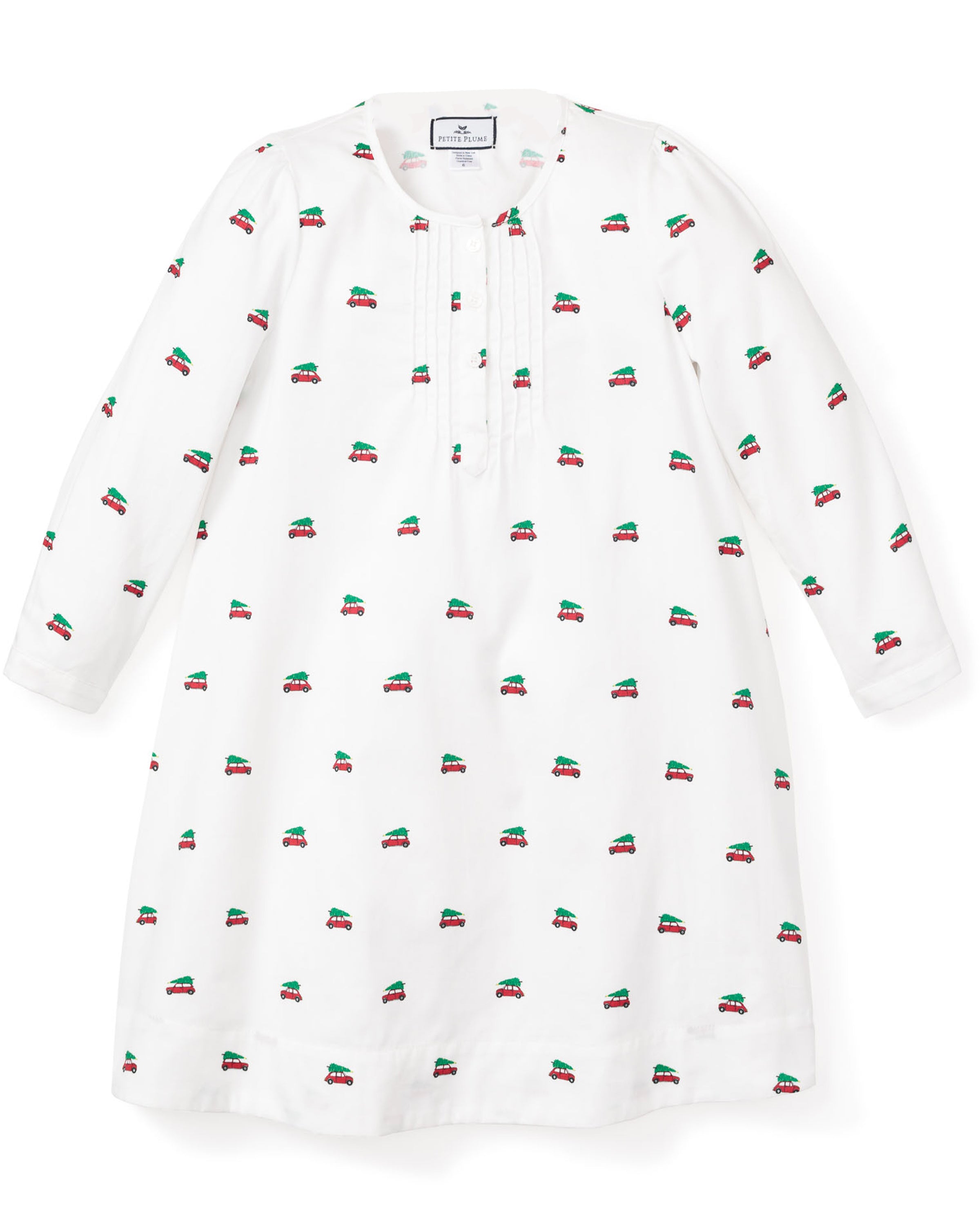 The Petite Plume Girls Twill Beatrice Nightgown in Holiday Journey is a white long-sleeved dress with red and green car patterns, featuring a round neckline and button placket, offering comfort and style for luxury sleepwear.