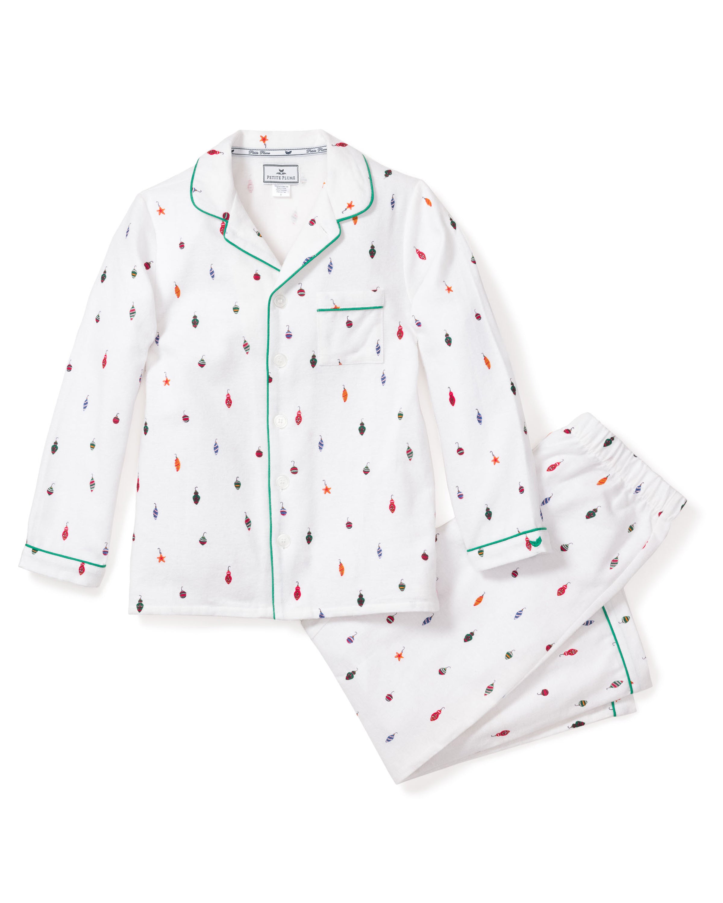 The Kids Flannel Pajama Set in Yuletide Ornaments by Petite Plume features long sleeves, pants, green piping, and a chest pocket. The luxurious white set with colorful feather prints is neatly arranged with the pants folded beside the top.